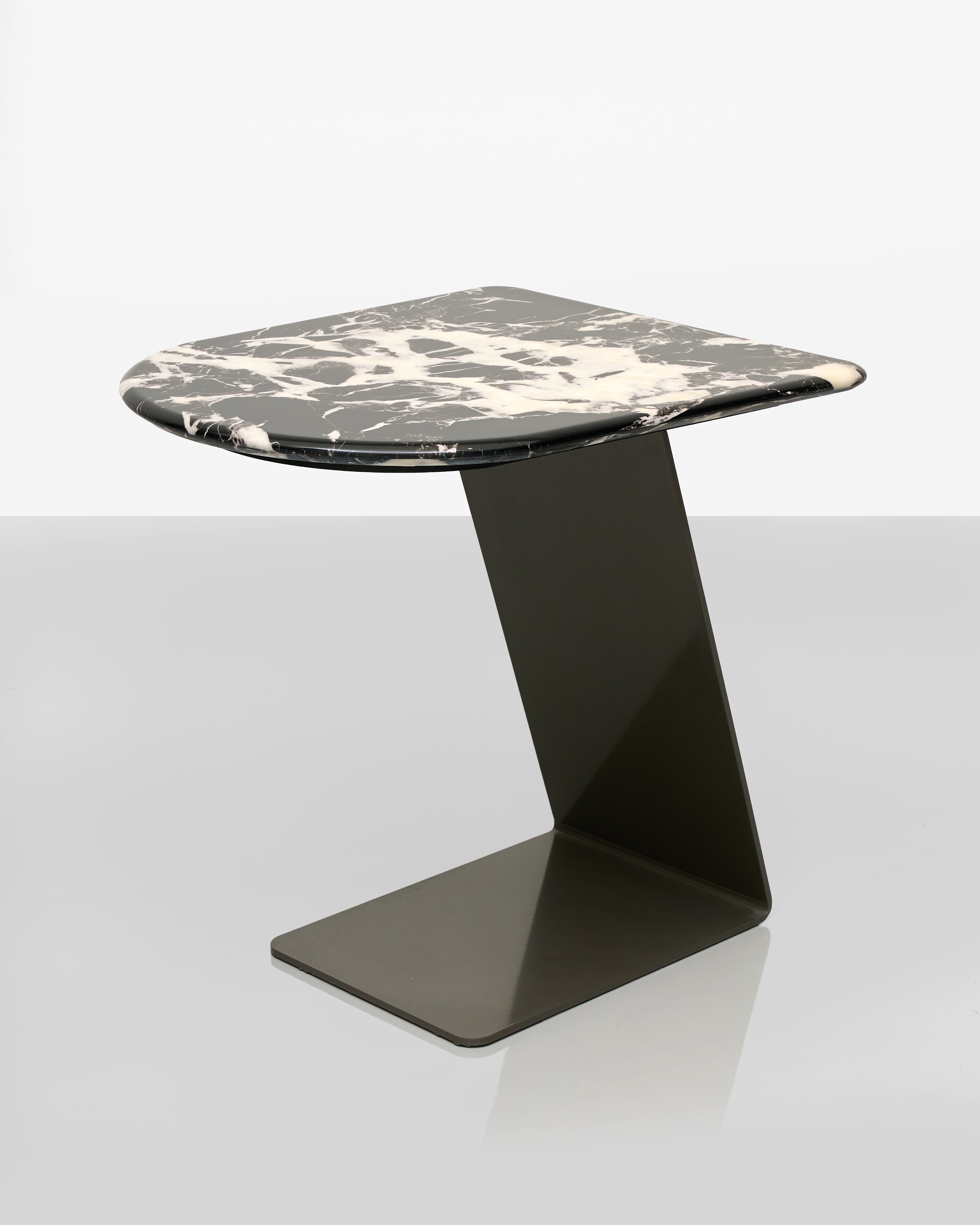 Modern side table with black and white marble top on a white background