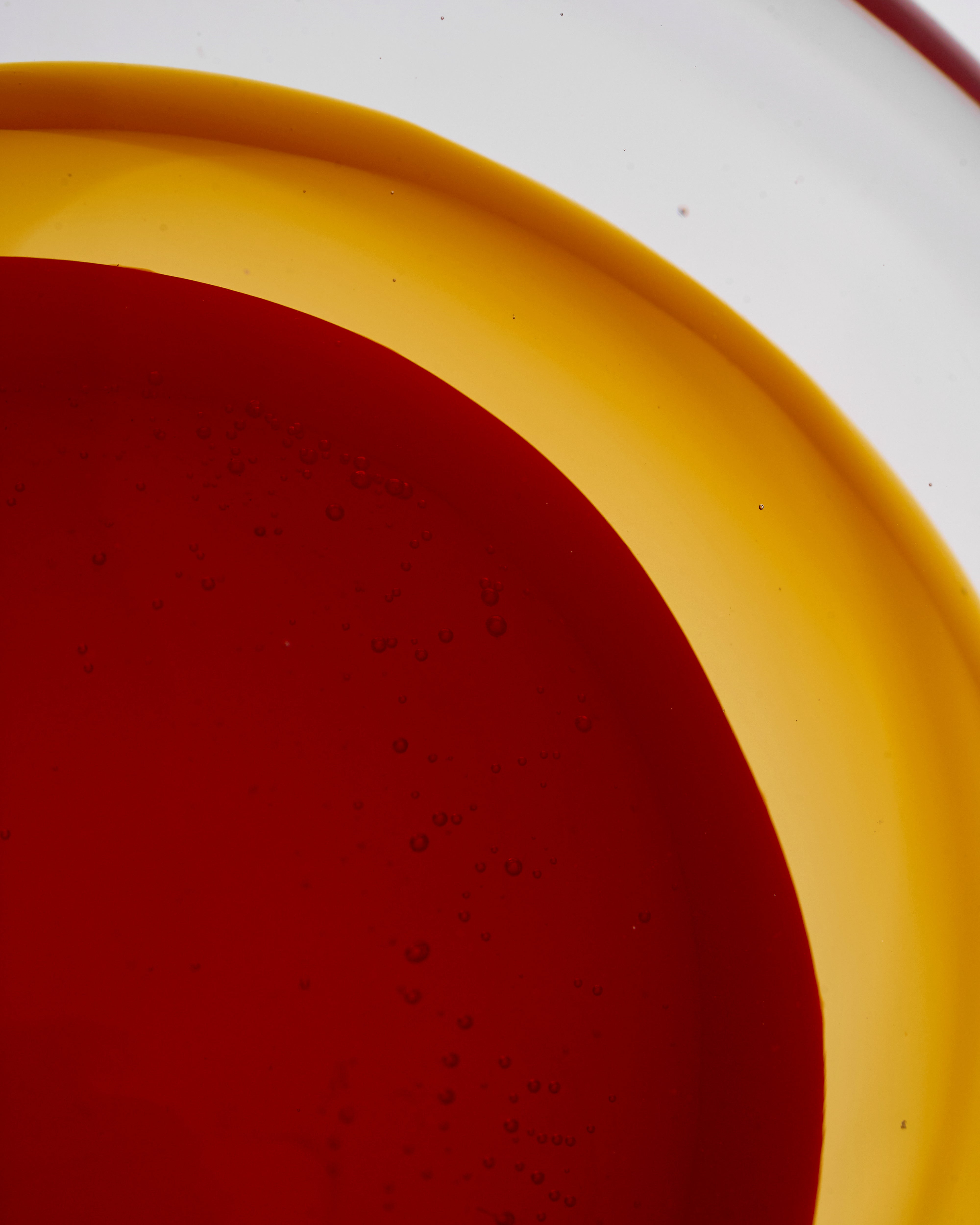 Close-up of a red and yellow circular object on a white background