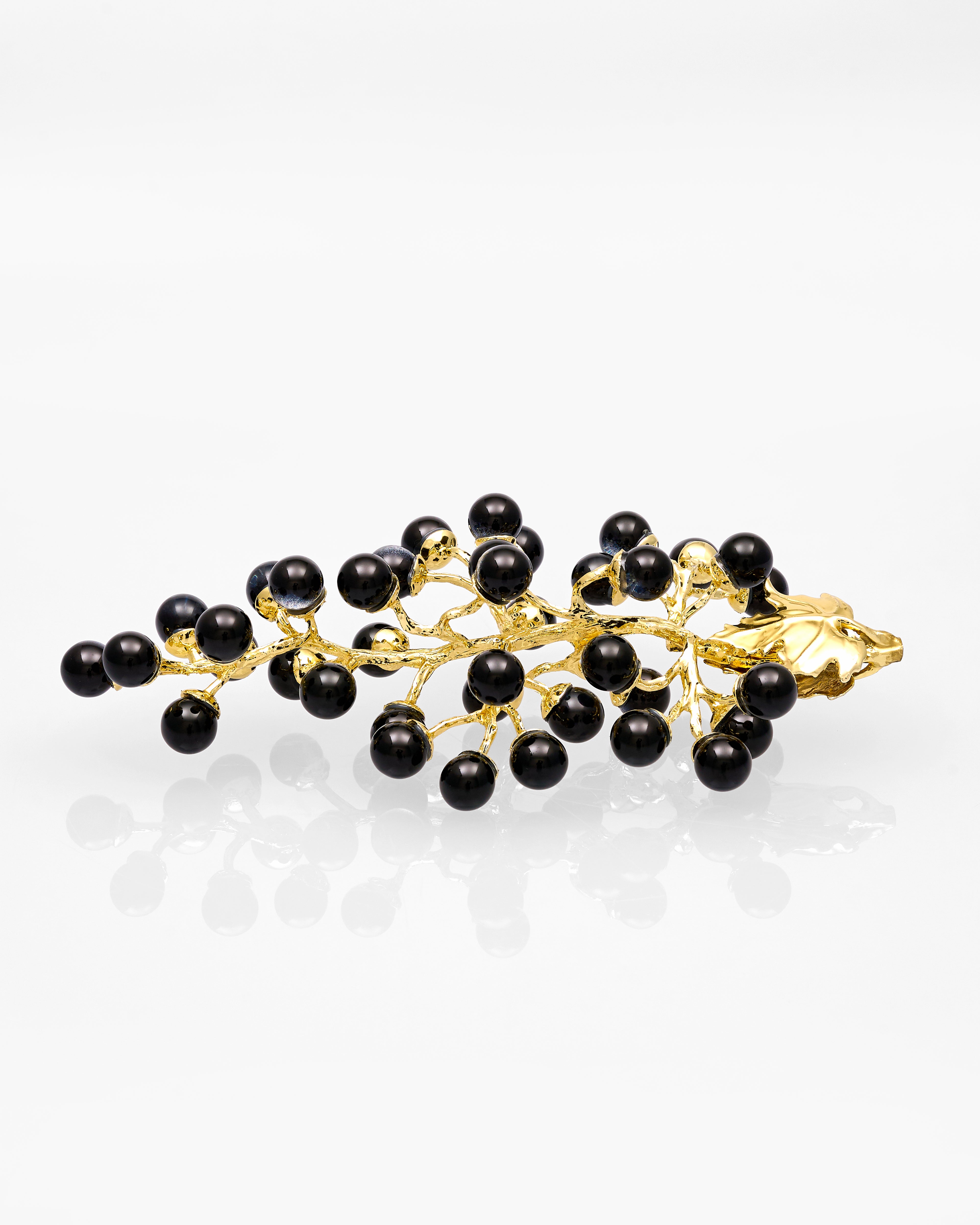 Gold & black metal decor with black beads on a white background