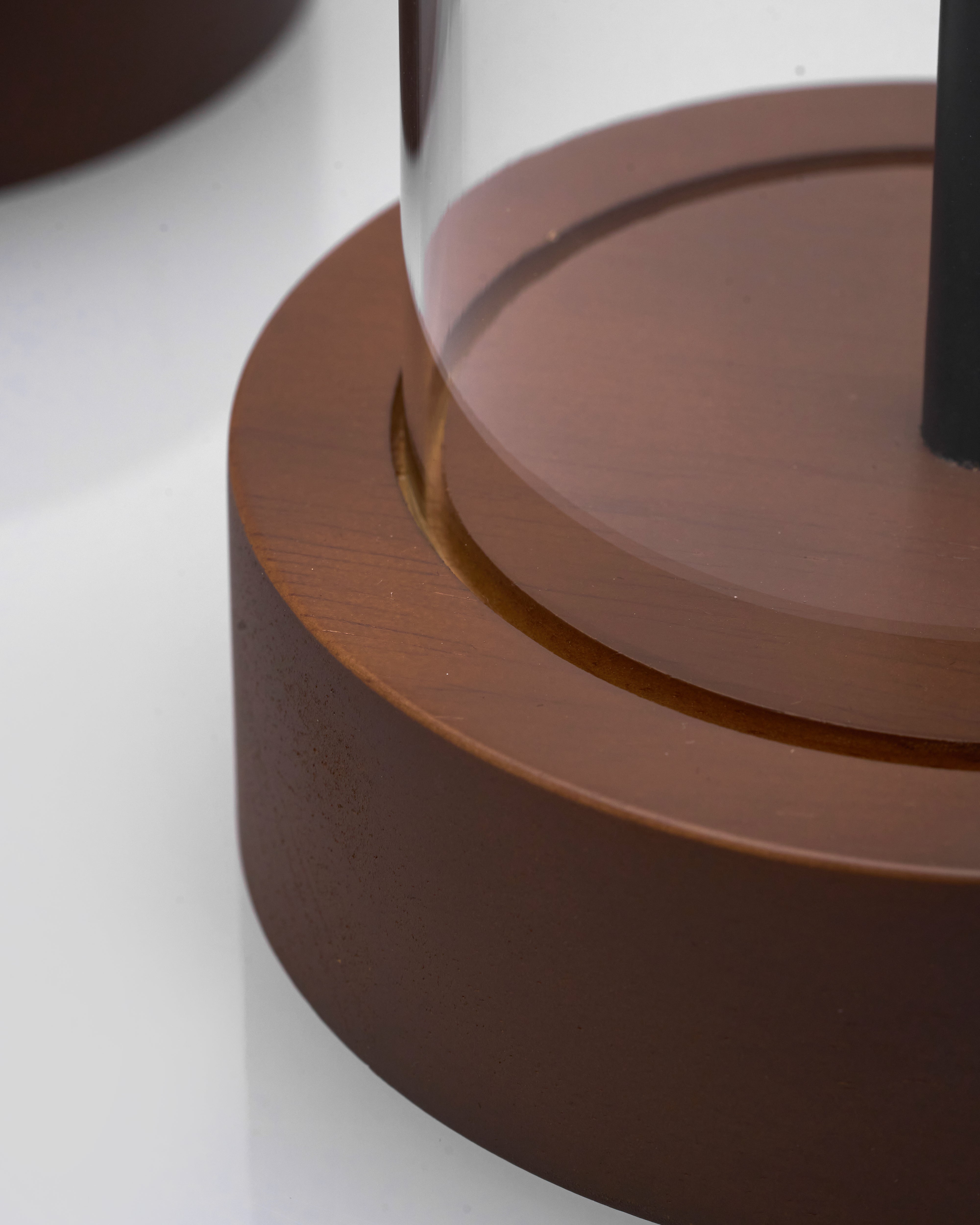 Close-up of a brown cylindrical object with a glass top on a white background