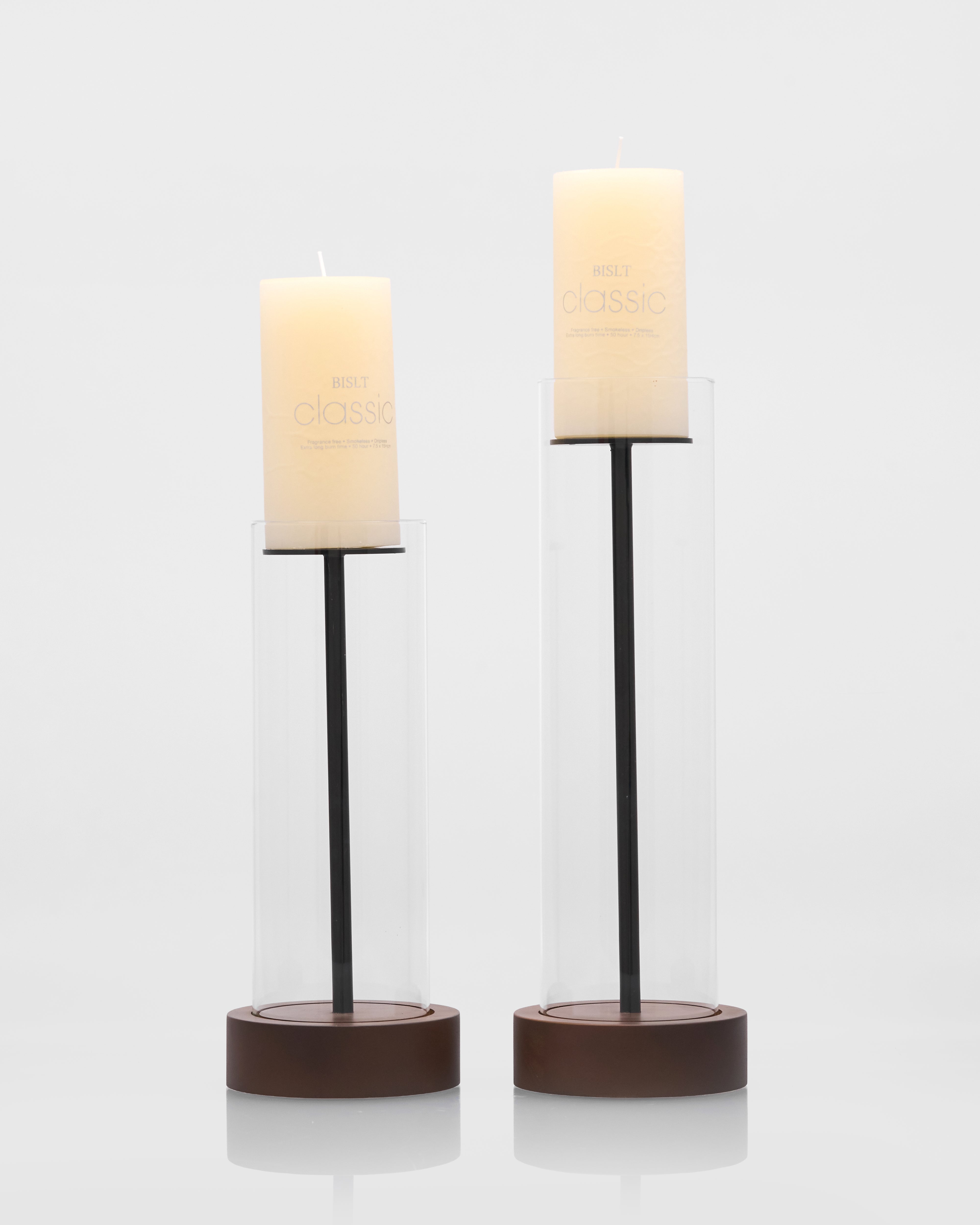 Two candle holders with candles on a white background
