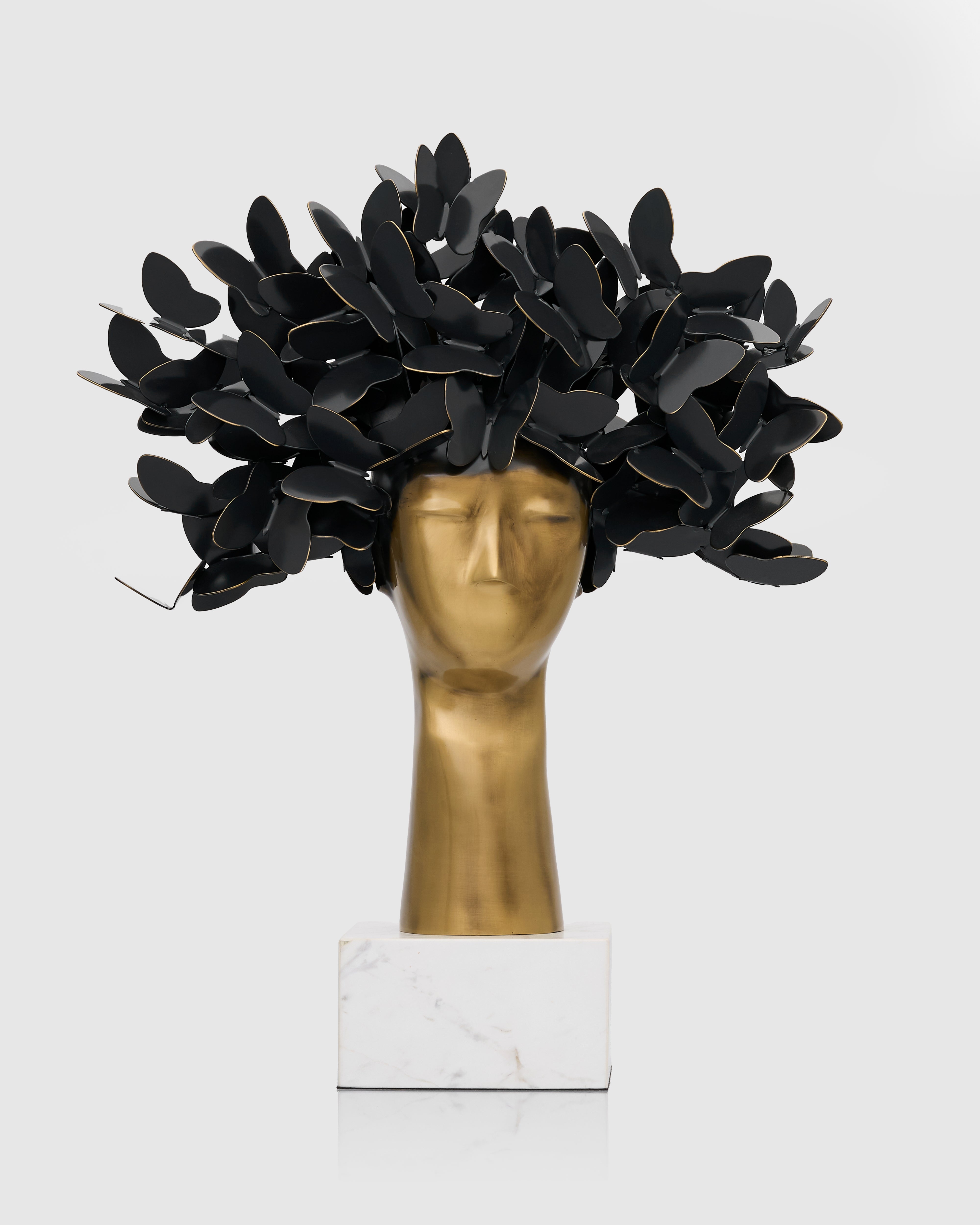 Black feathered headpiece on a mannequin head with a white background