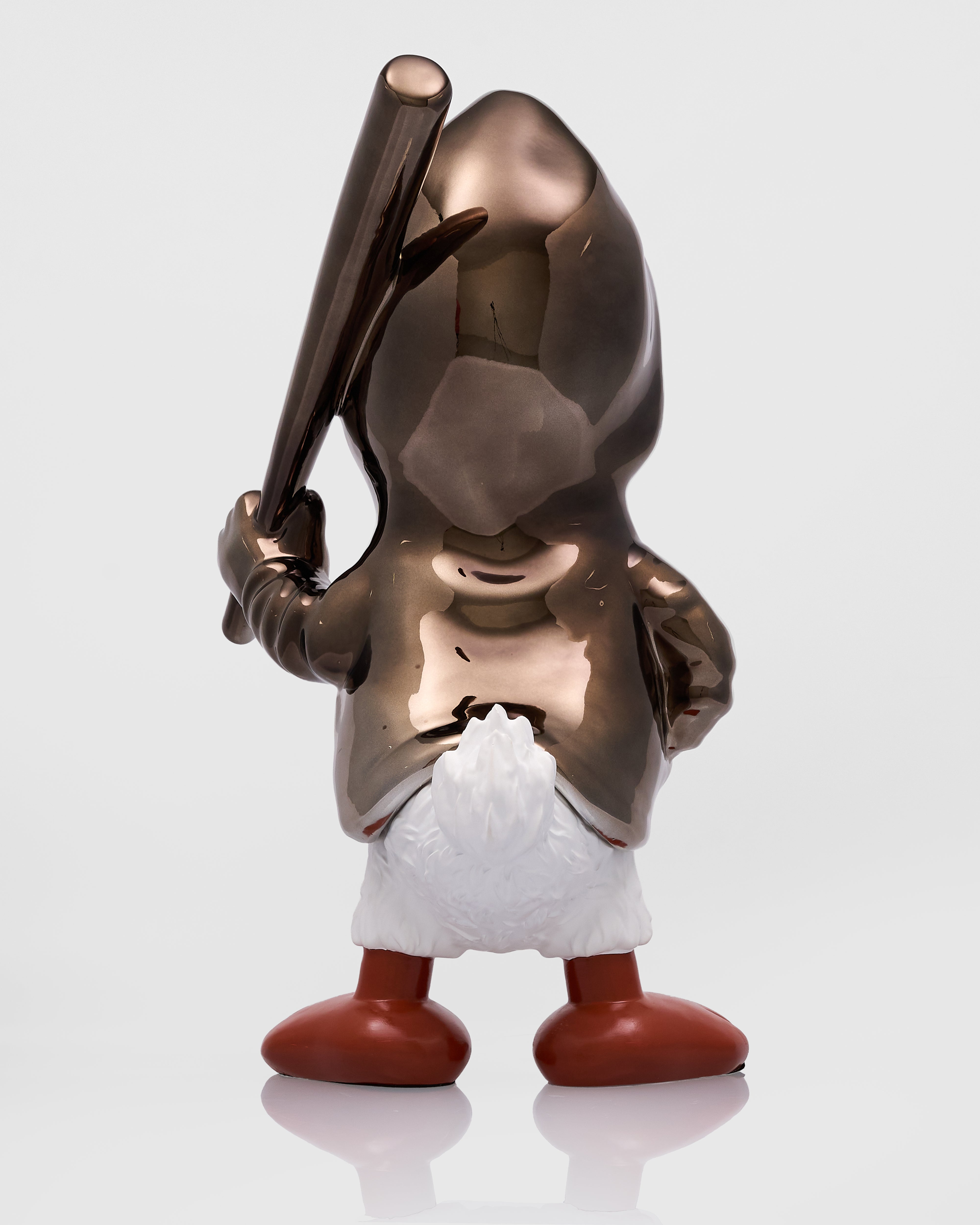 Metallic figurine of a character holding a baseball bat on a white background