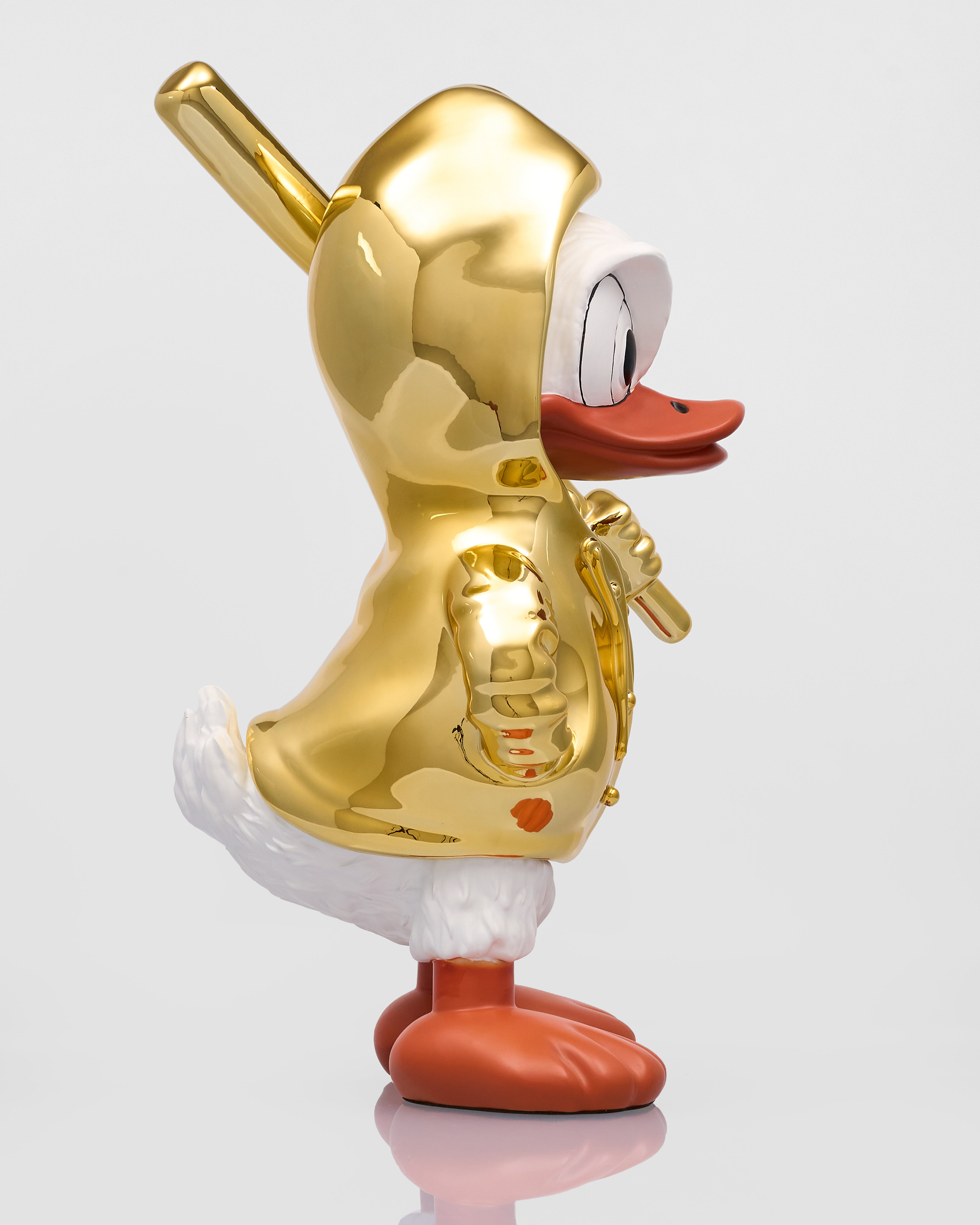 Gold duck figurine with a white background