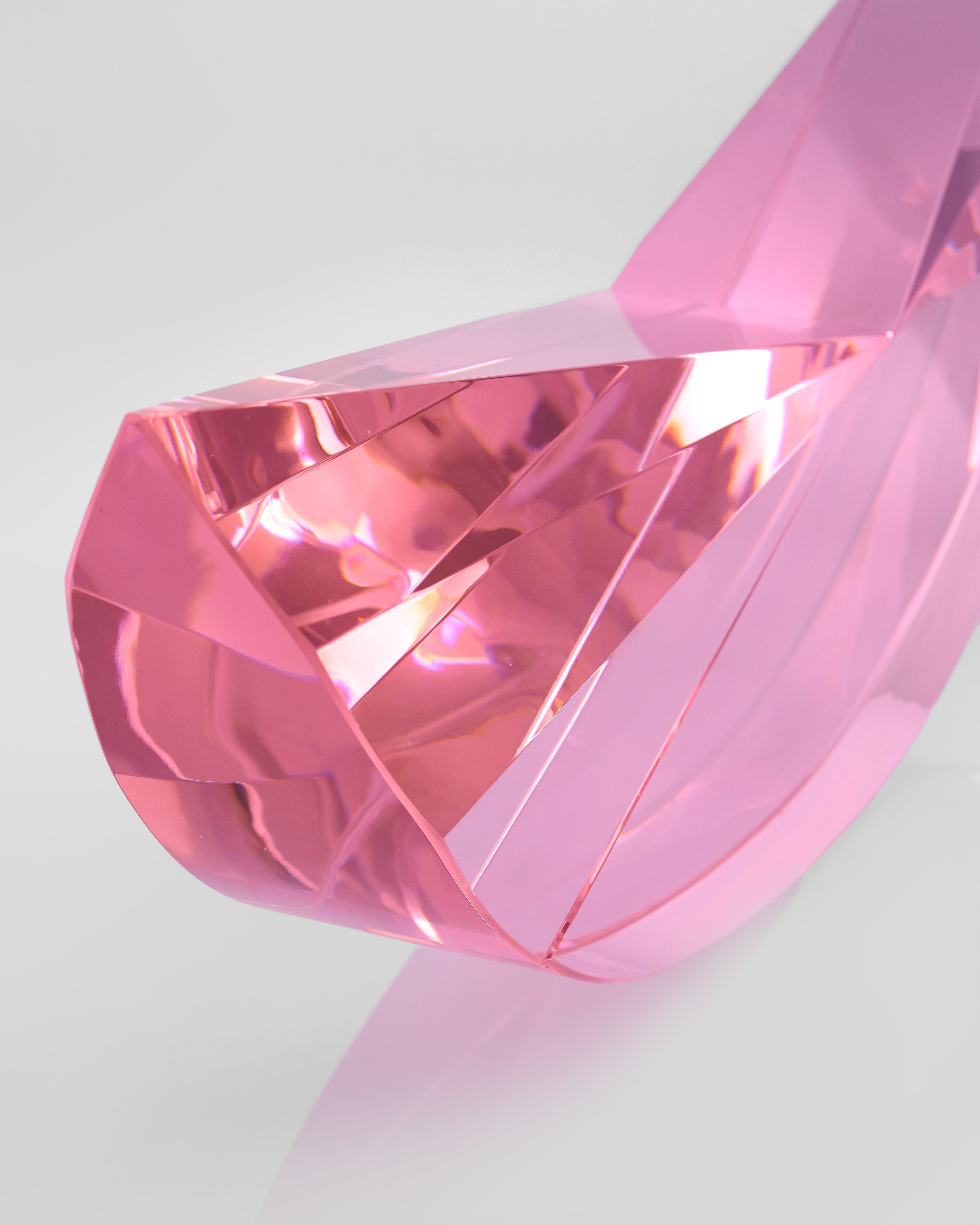Pink crystal-like object on a light gray background