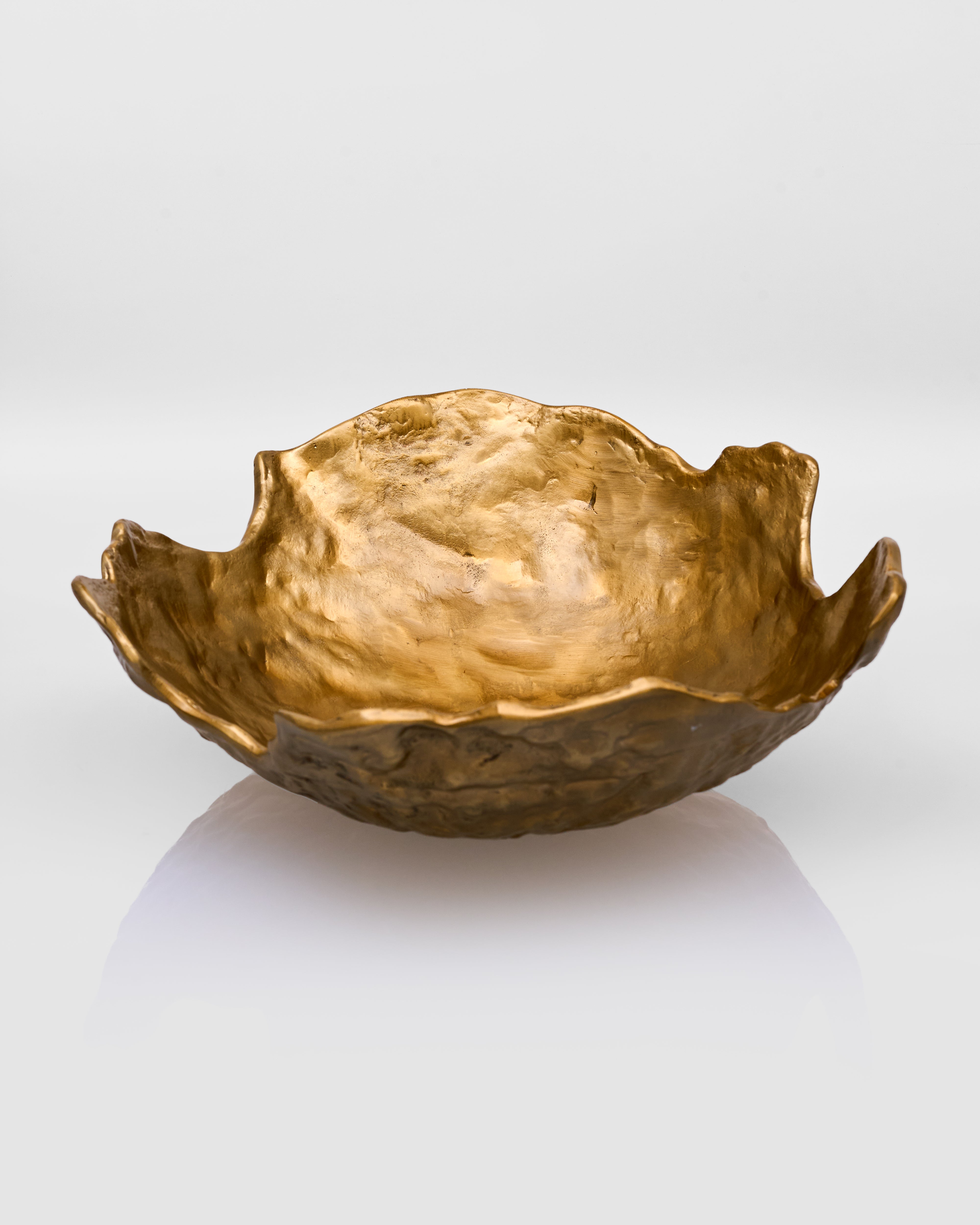 Gold leaf-shaped bowl on a white background