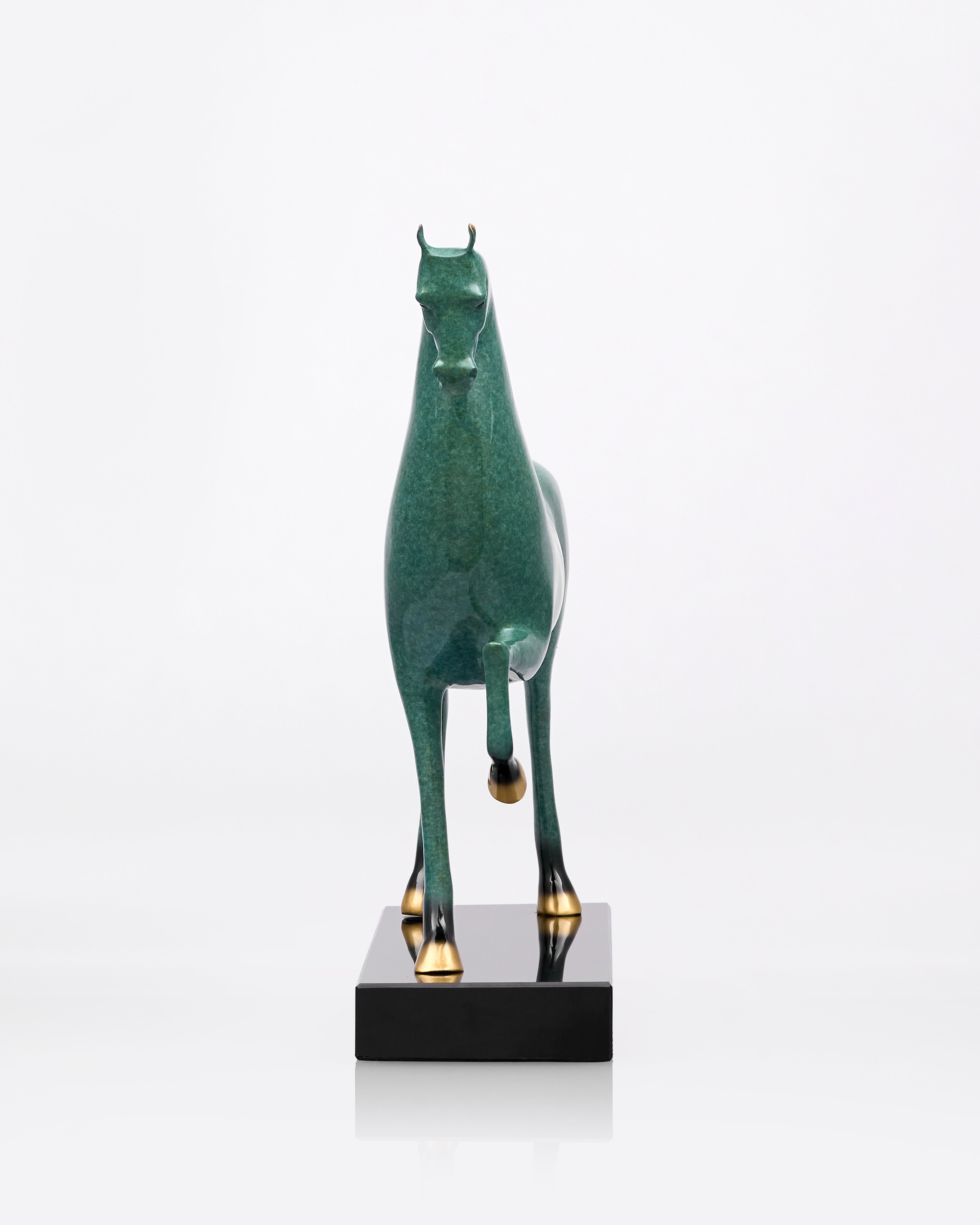 Green horse sculpture on a white background
