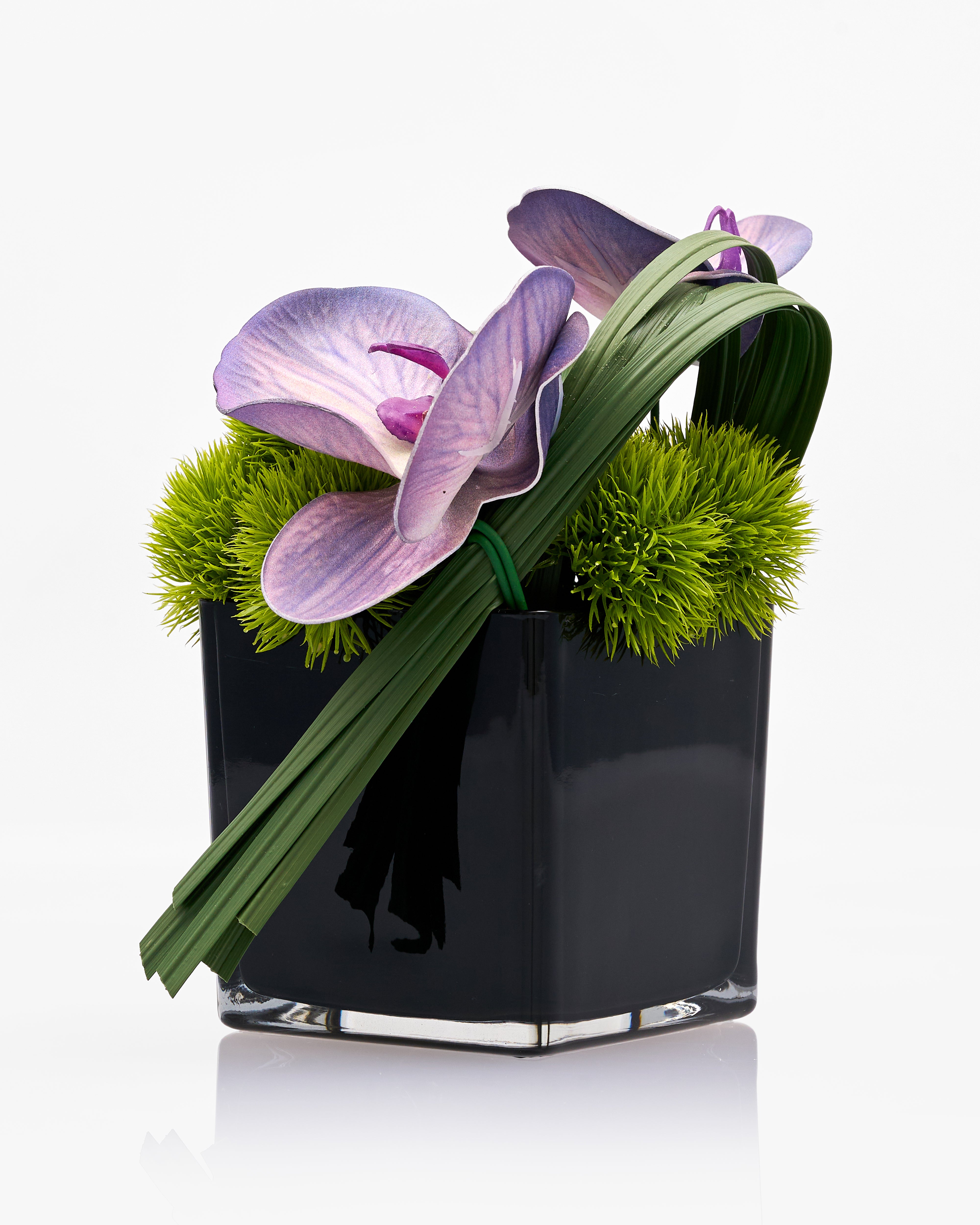 Black vase with purple flower and greenery on a white background