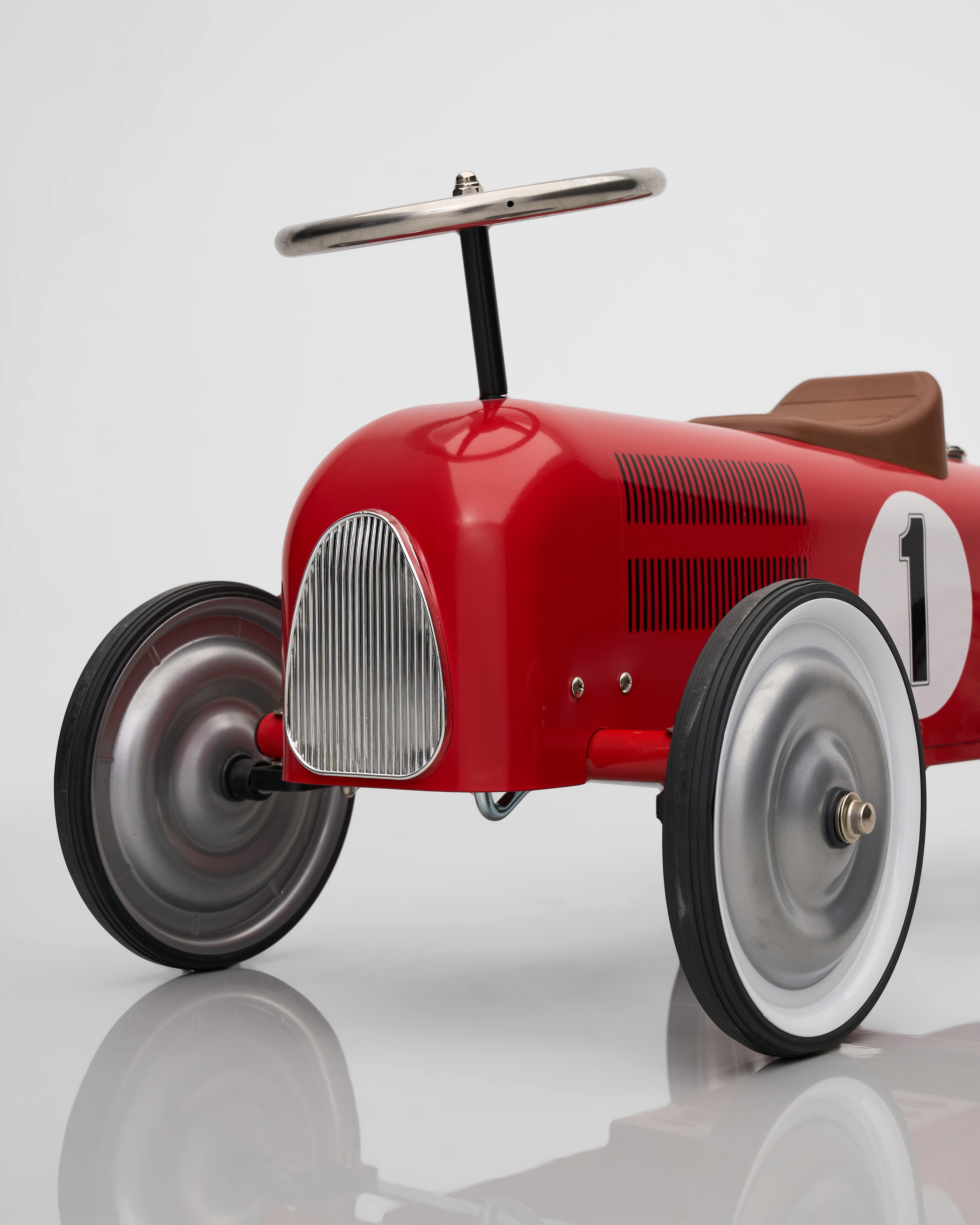 Red toy car with number 1 on a reflective surface