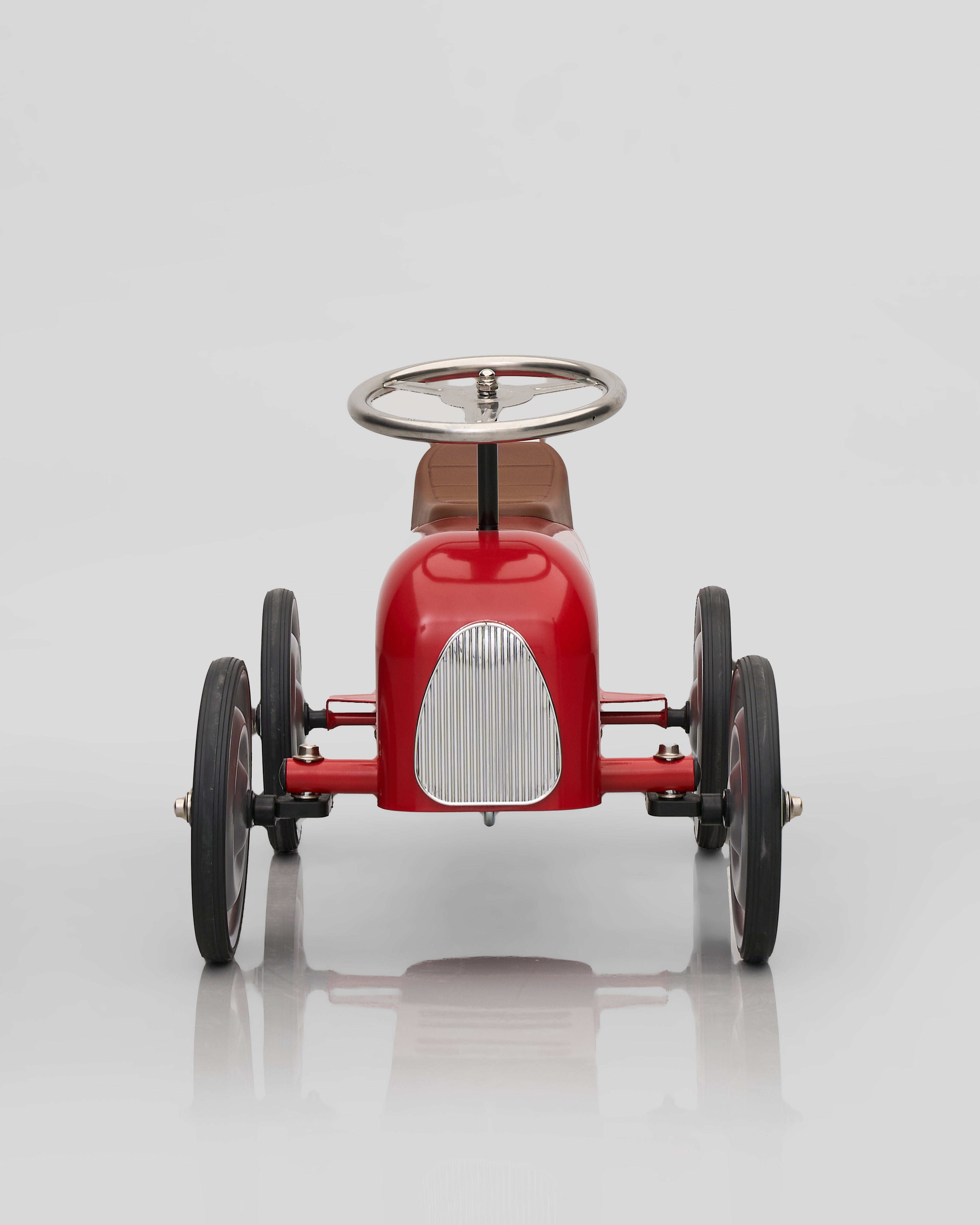 Red vintage-style toy car decor on a white background