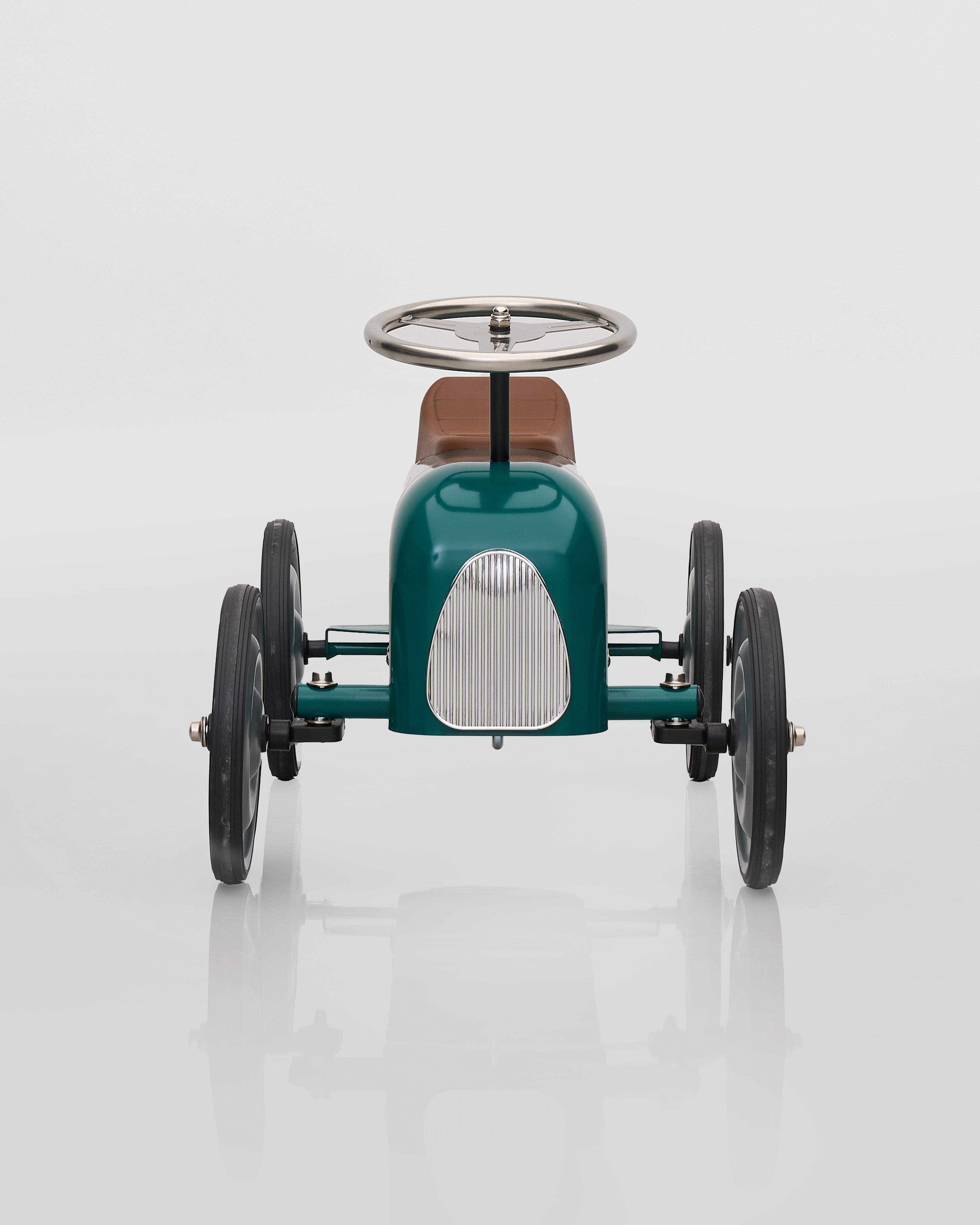 Green vintage-style toy car on a white background