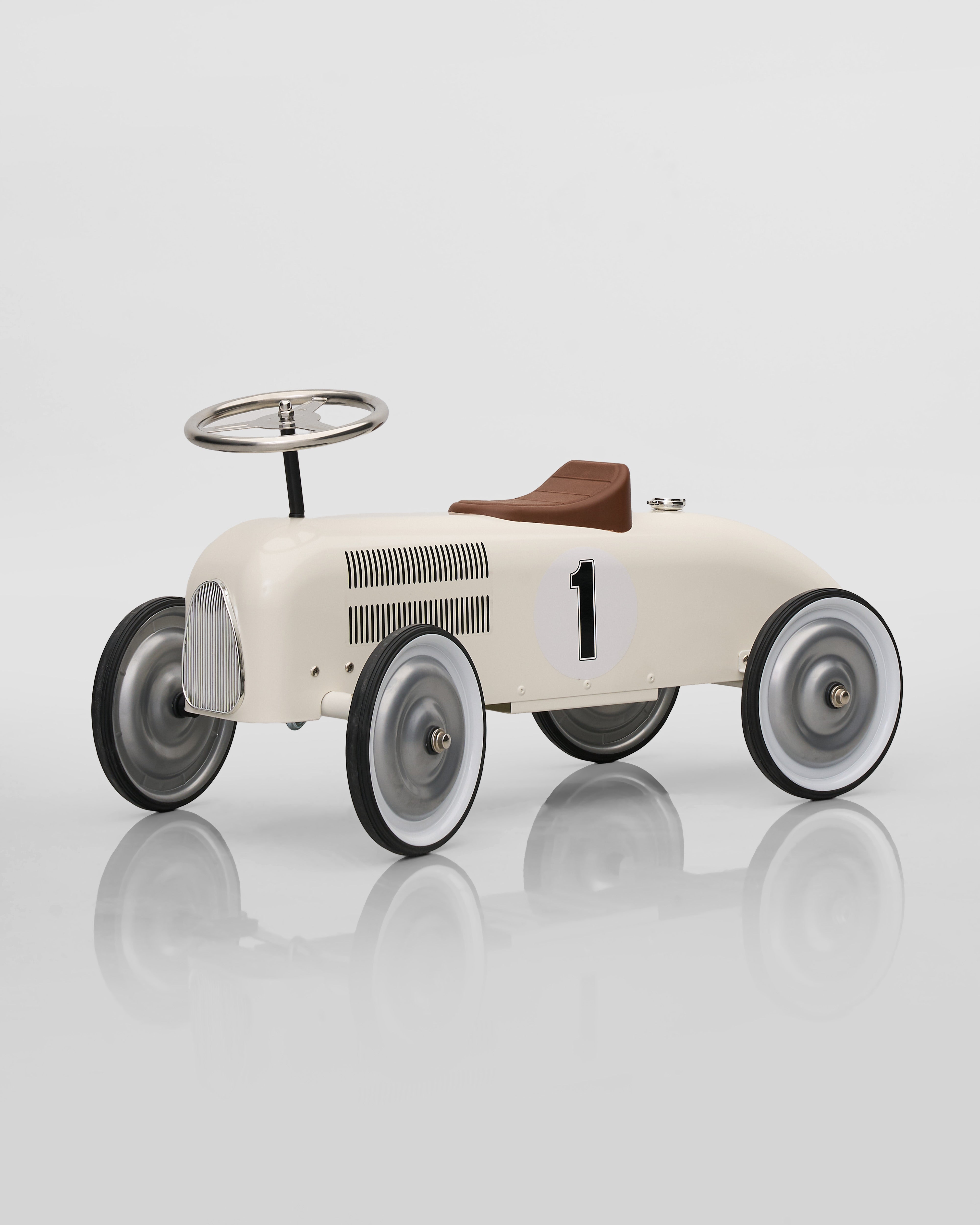 Vintage-style toy car with number 1 on a reflective surface