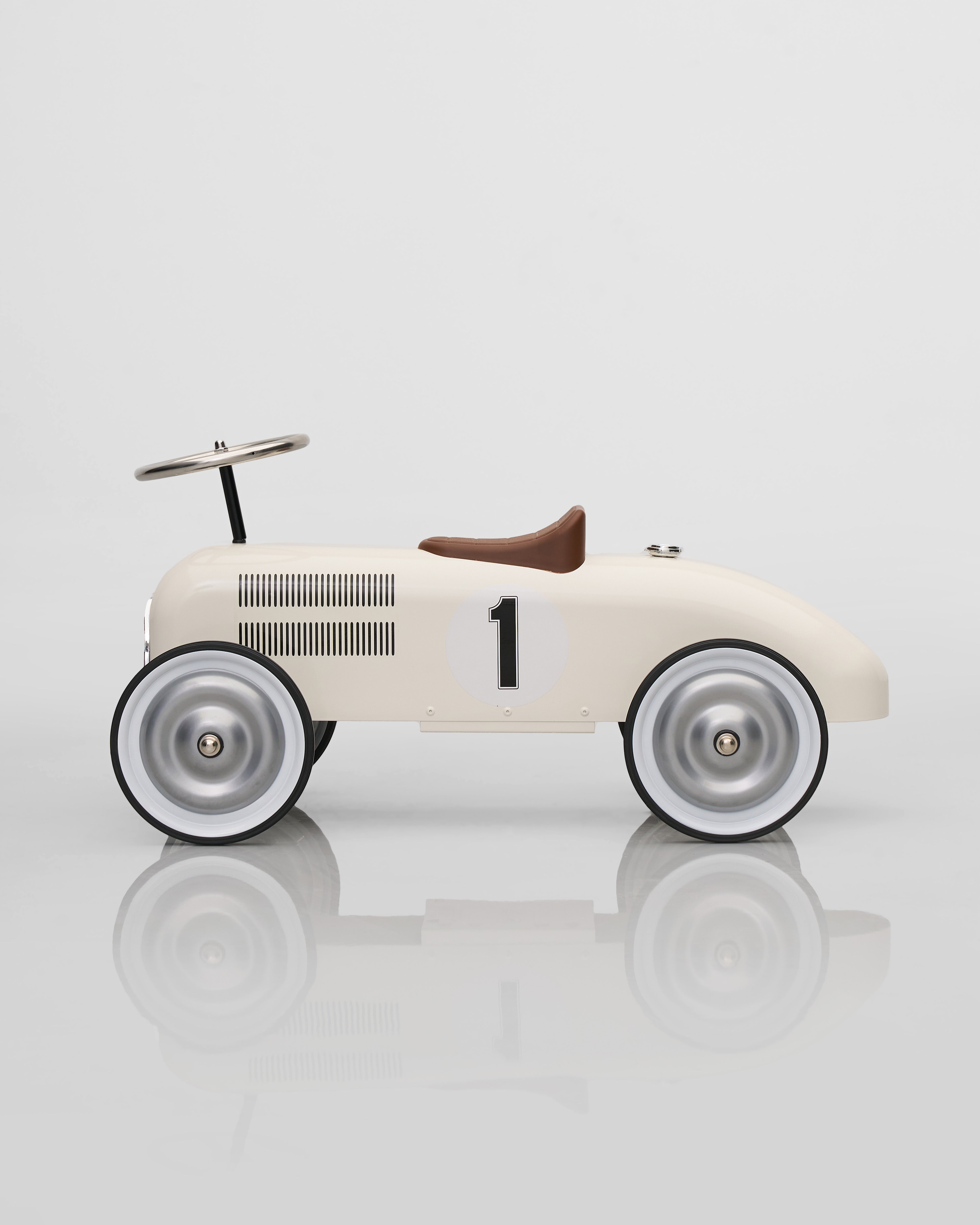 Vintage-style toy car with number 1 on a reflective surface
