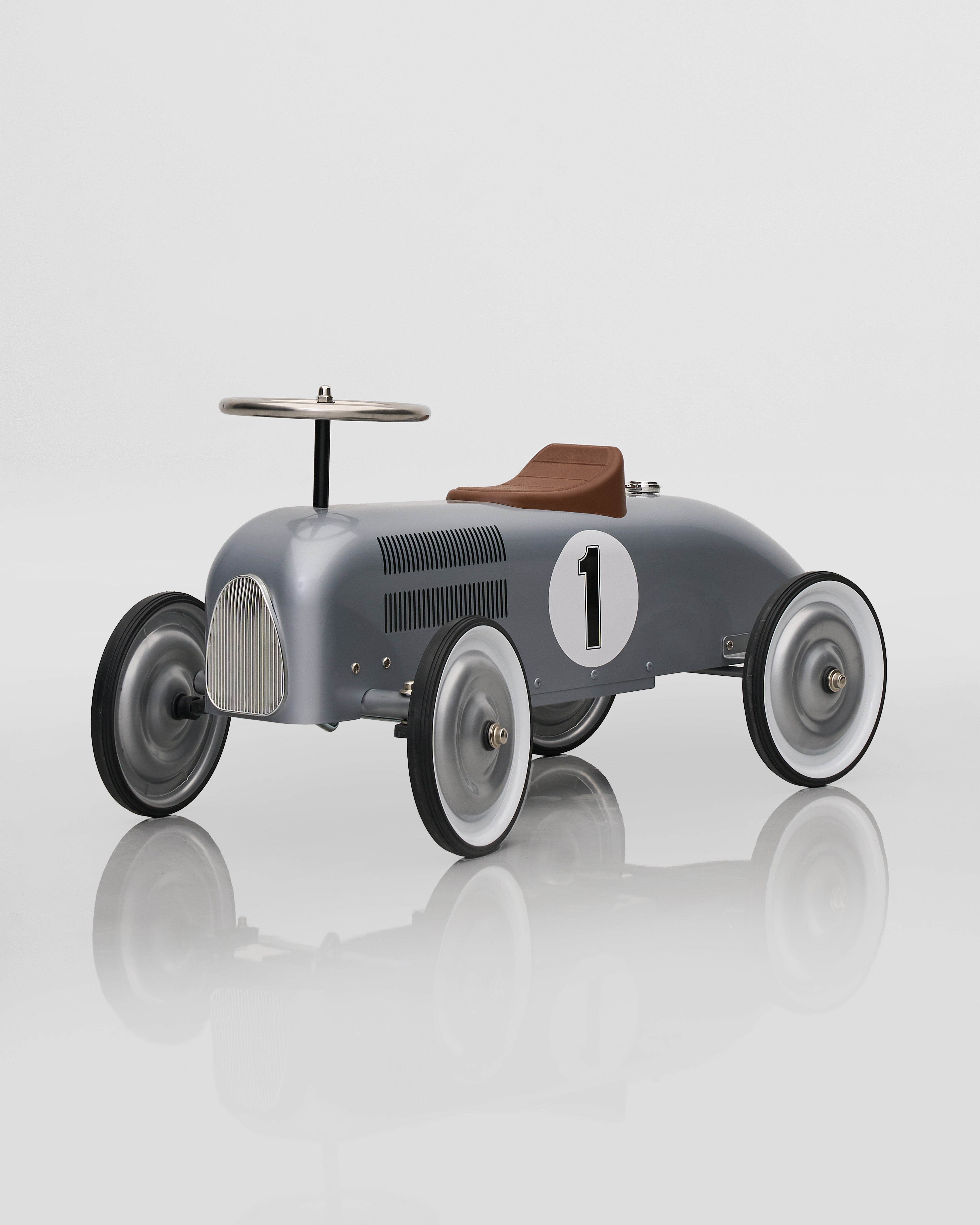 Vintage-style toy car with number 1 on a reflective surface