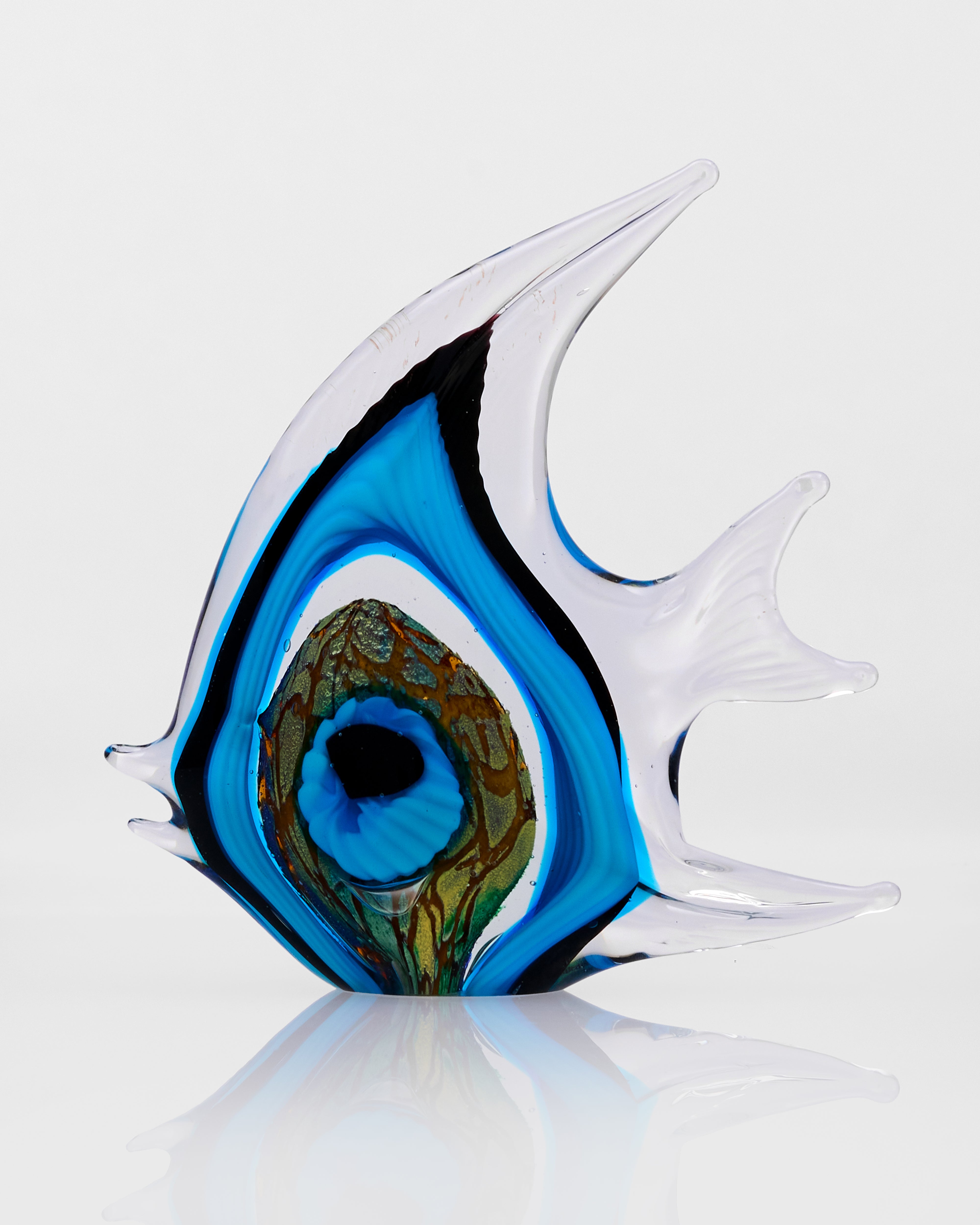 Glass sculpture of a fish with blue and green colors on a white background