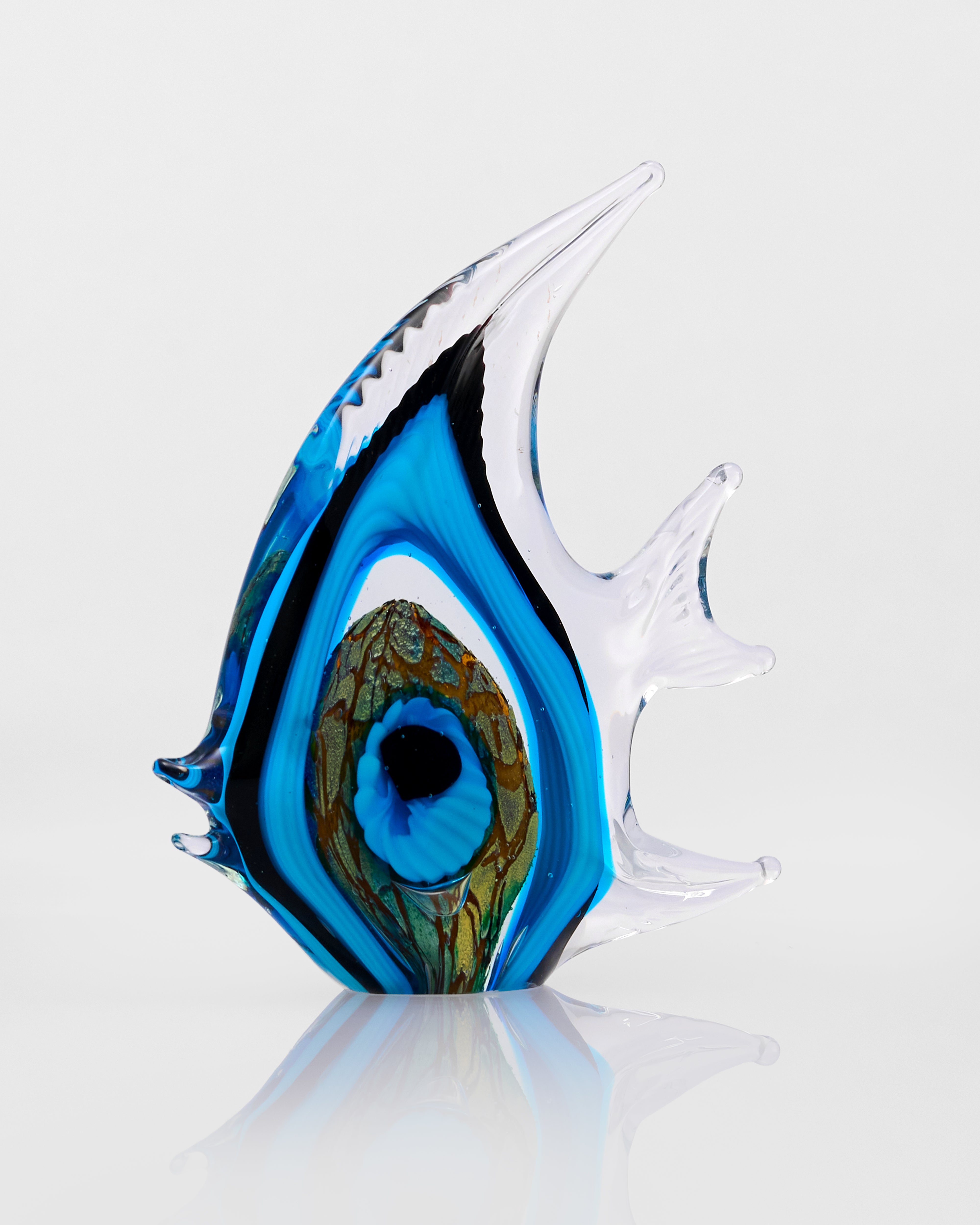 Glass fish sculpture with blue, white and green colors on a white background