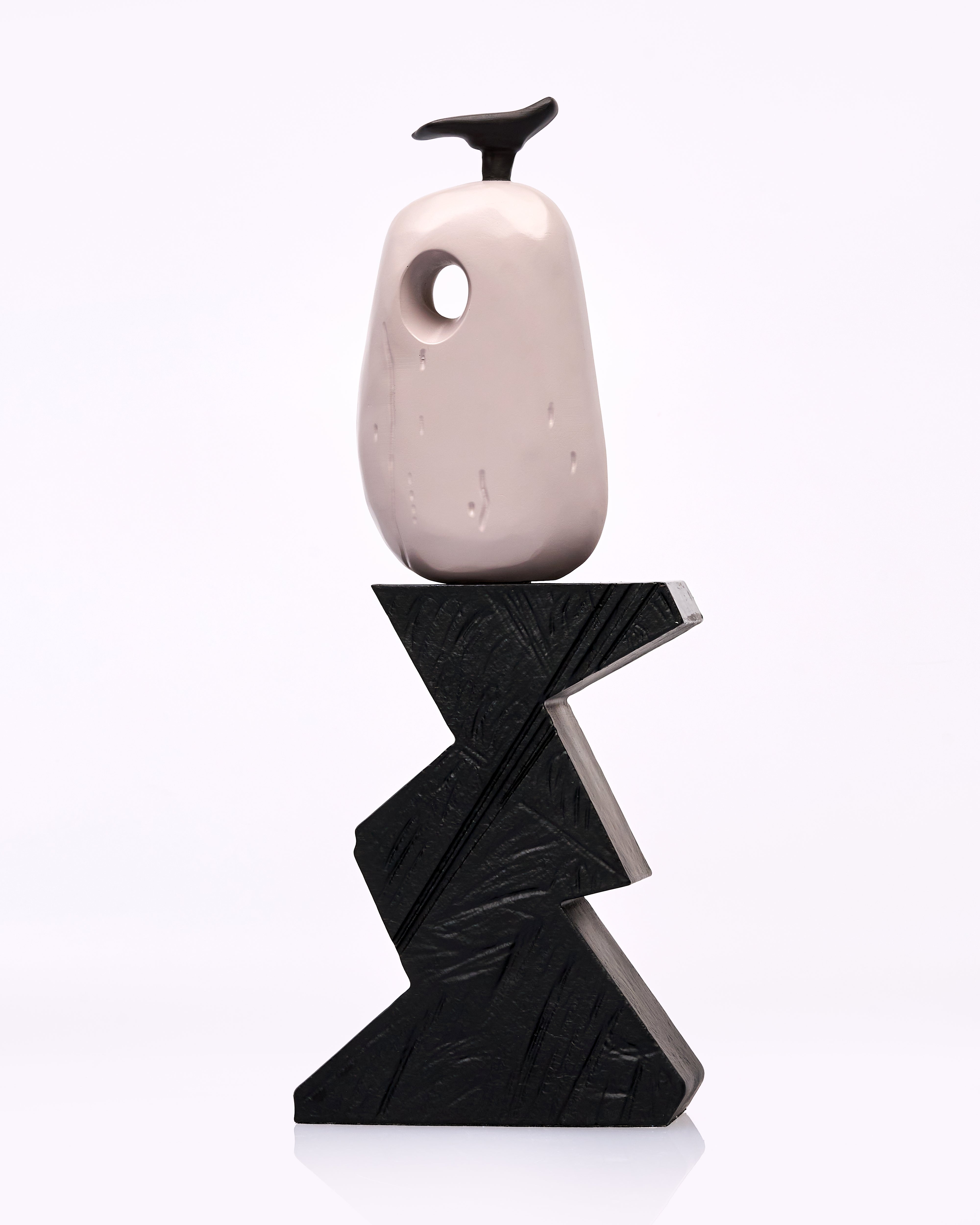 wooden vase on a black zigzag stand against a white background