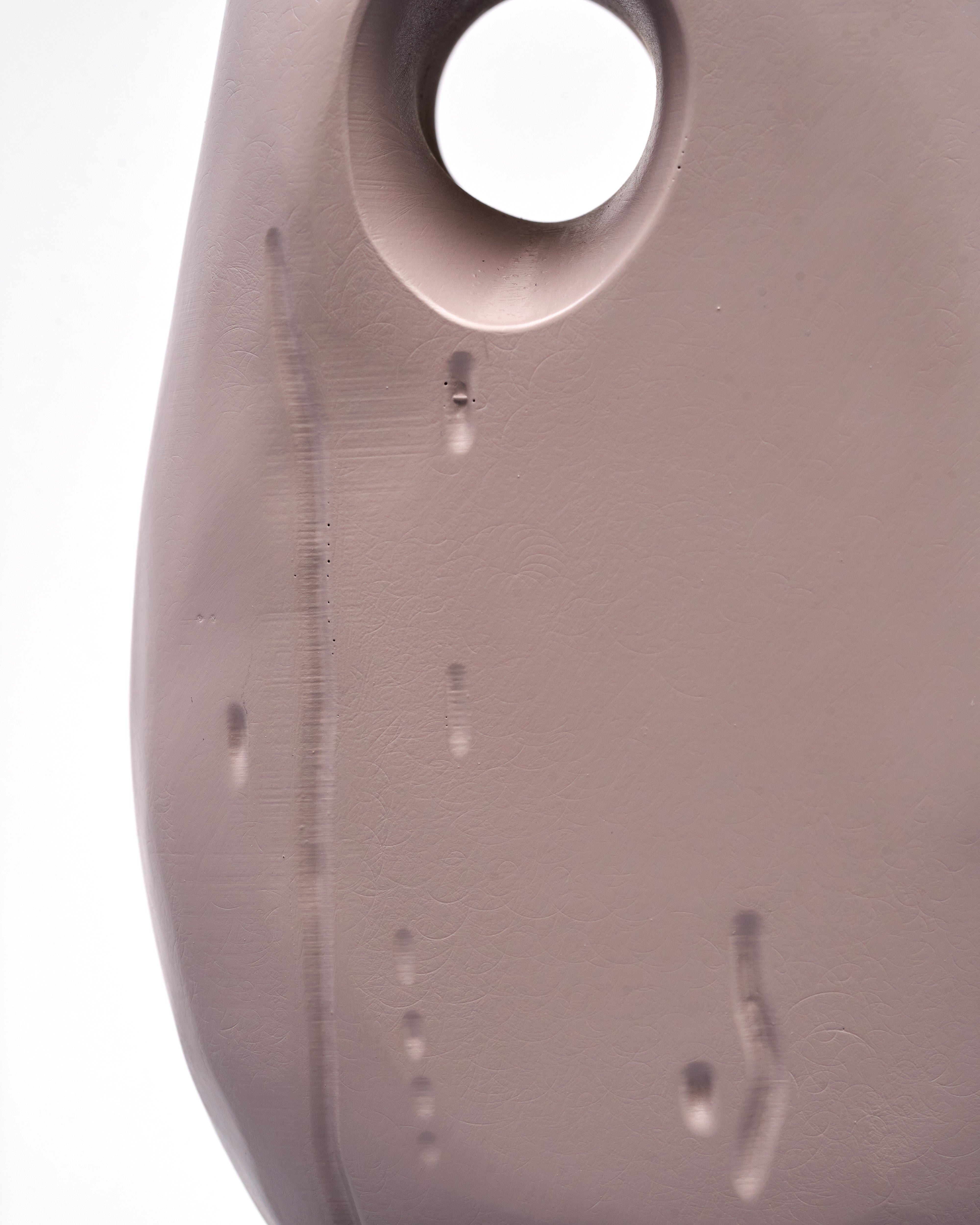 Close-up of a textured wooden vase on a white background