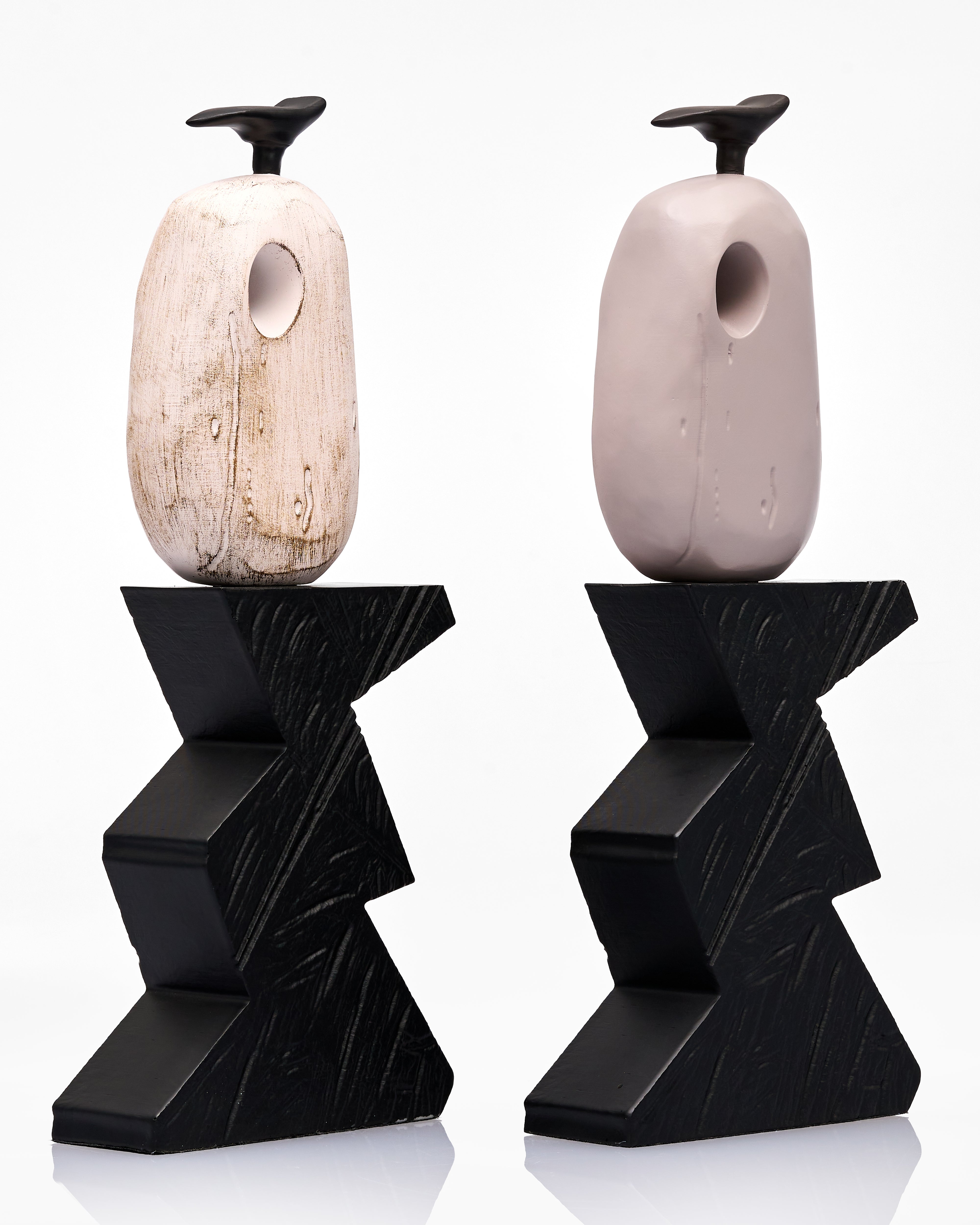 Two wooden decor with black geometric bases on a white background