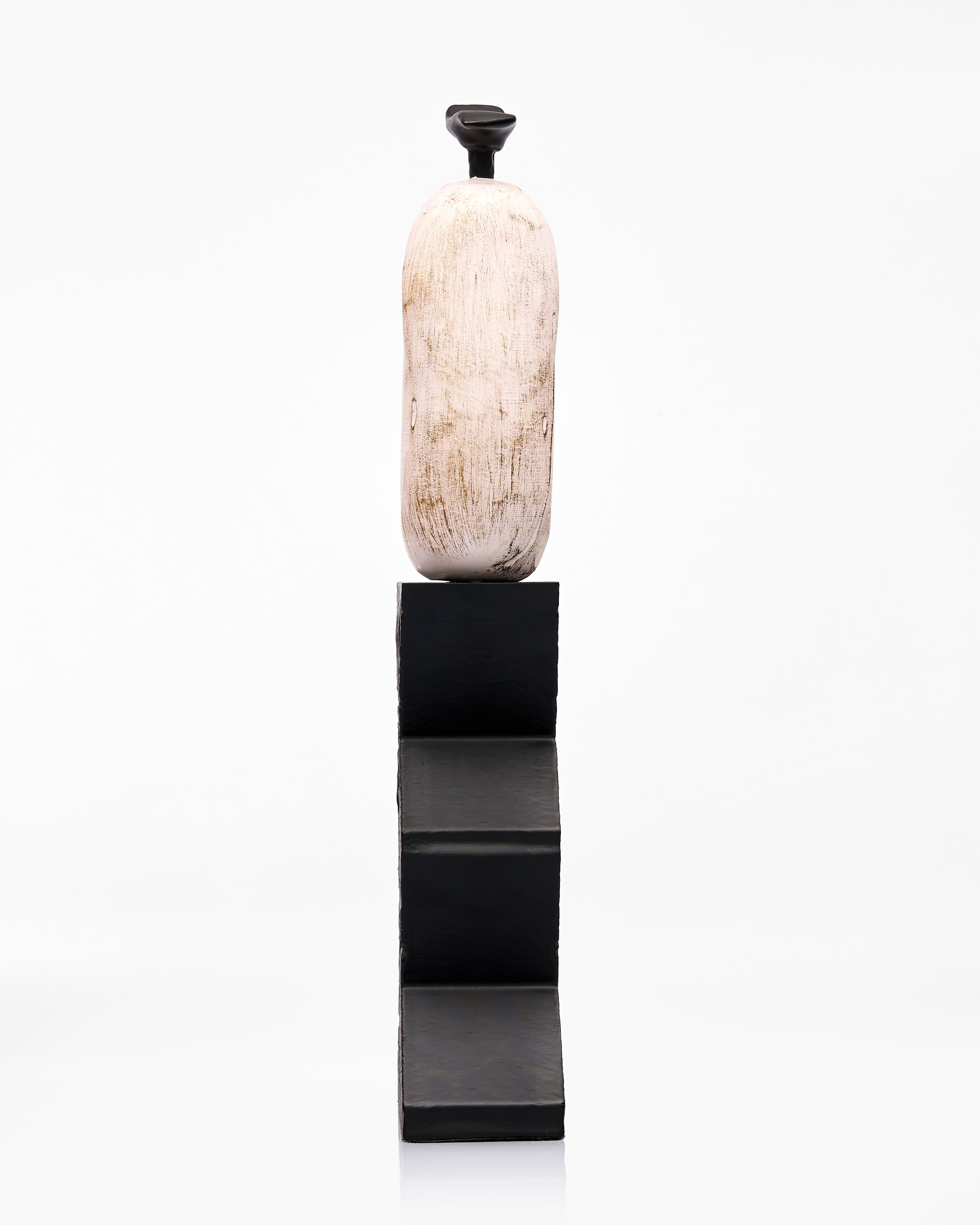 Decorative wooden handwash on a black pedestal against a white background
