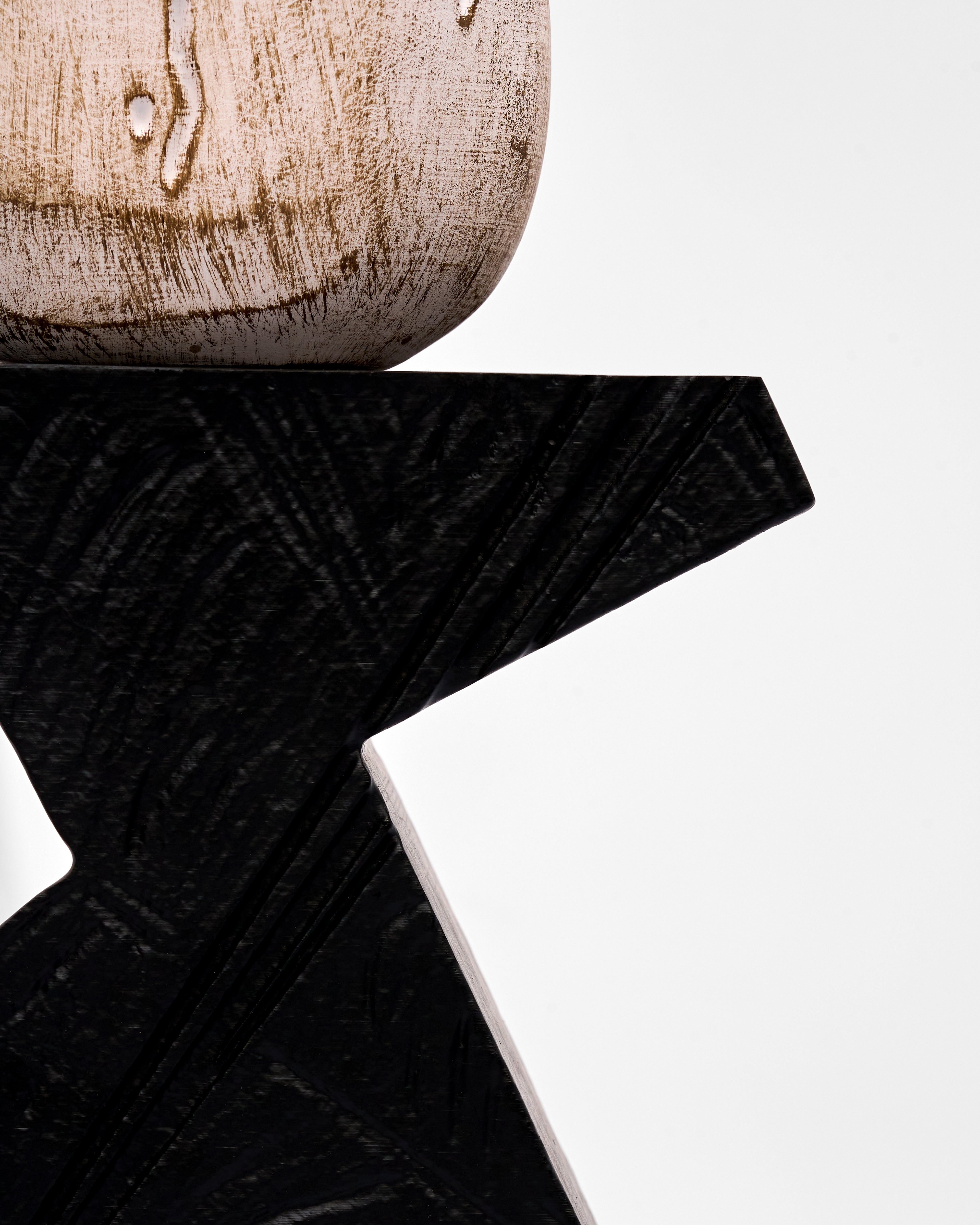Close-up of a wooden base of hand wash decor with a black strap on a white background