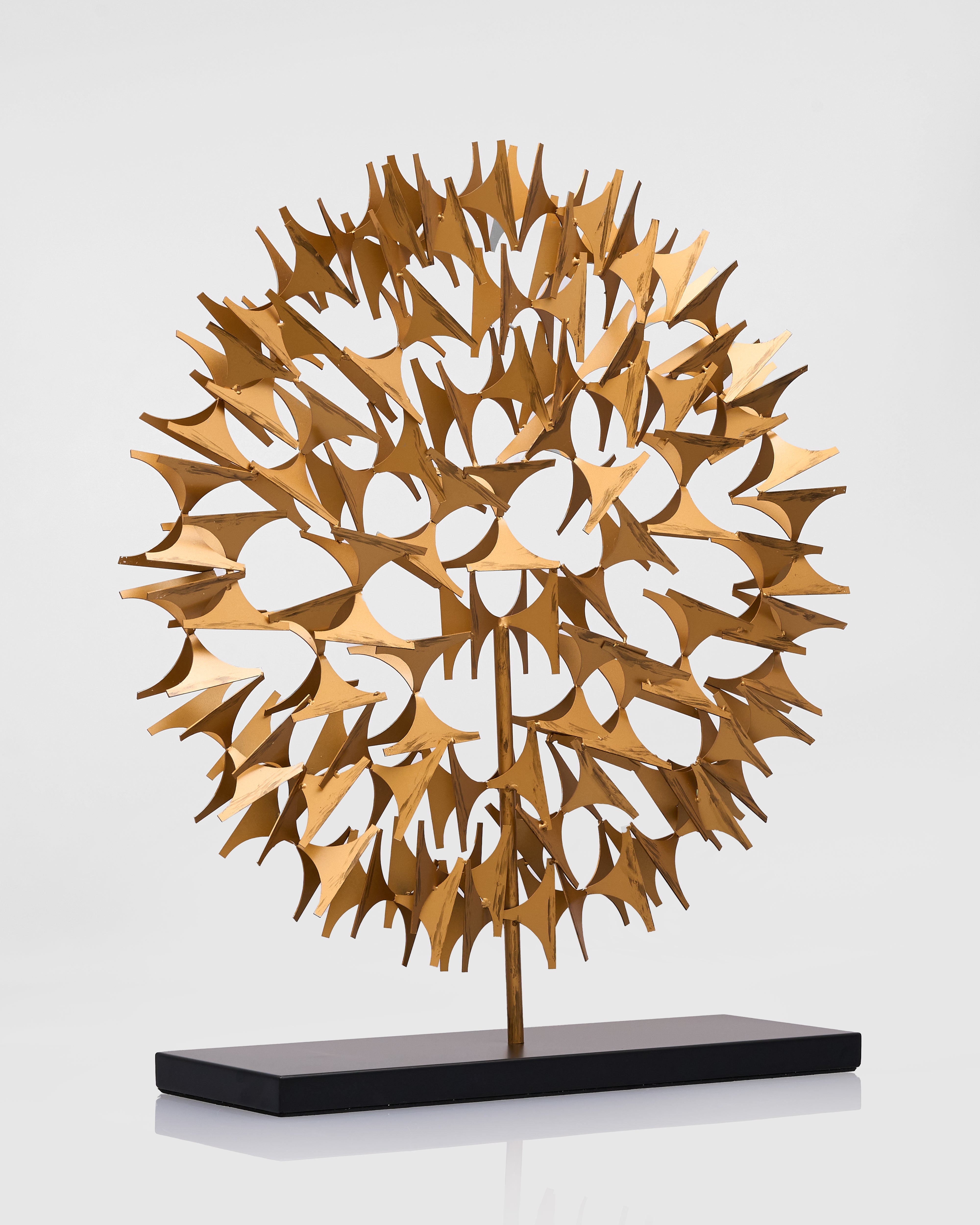 Gold metal sculpture on a white background