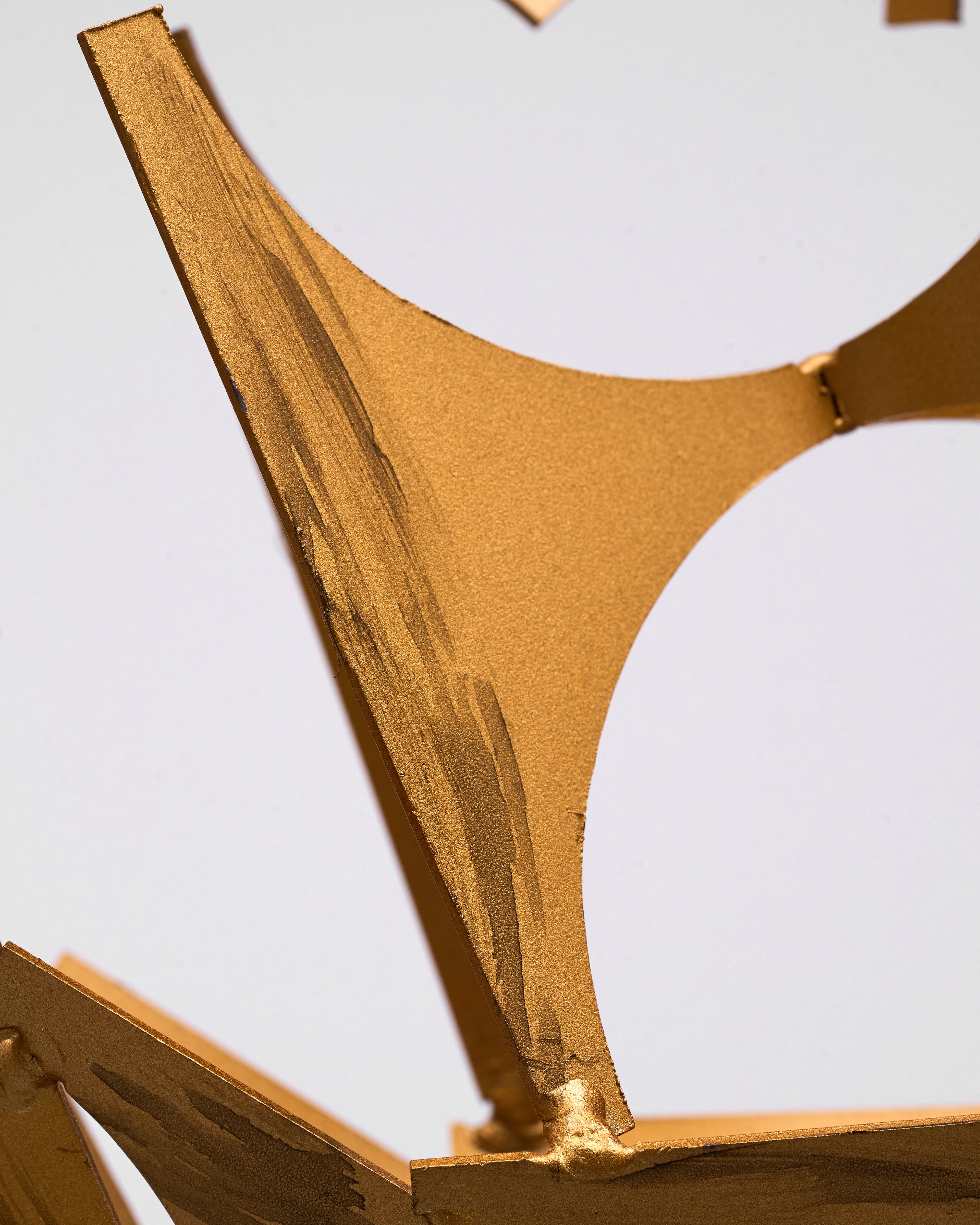 Close-up of a bronze sculpture with a white background