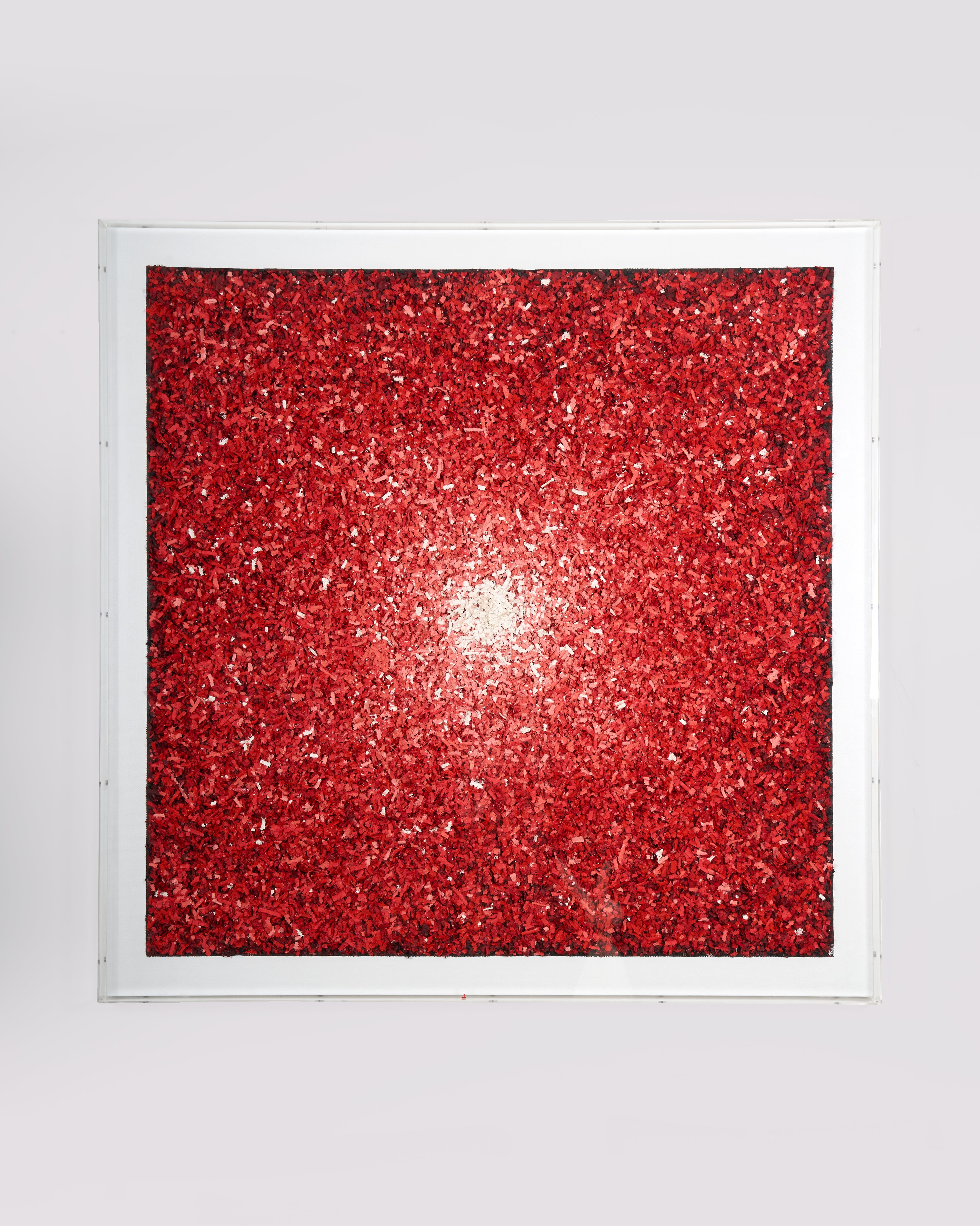 Framed red glittery artwork on a white background