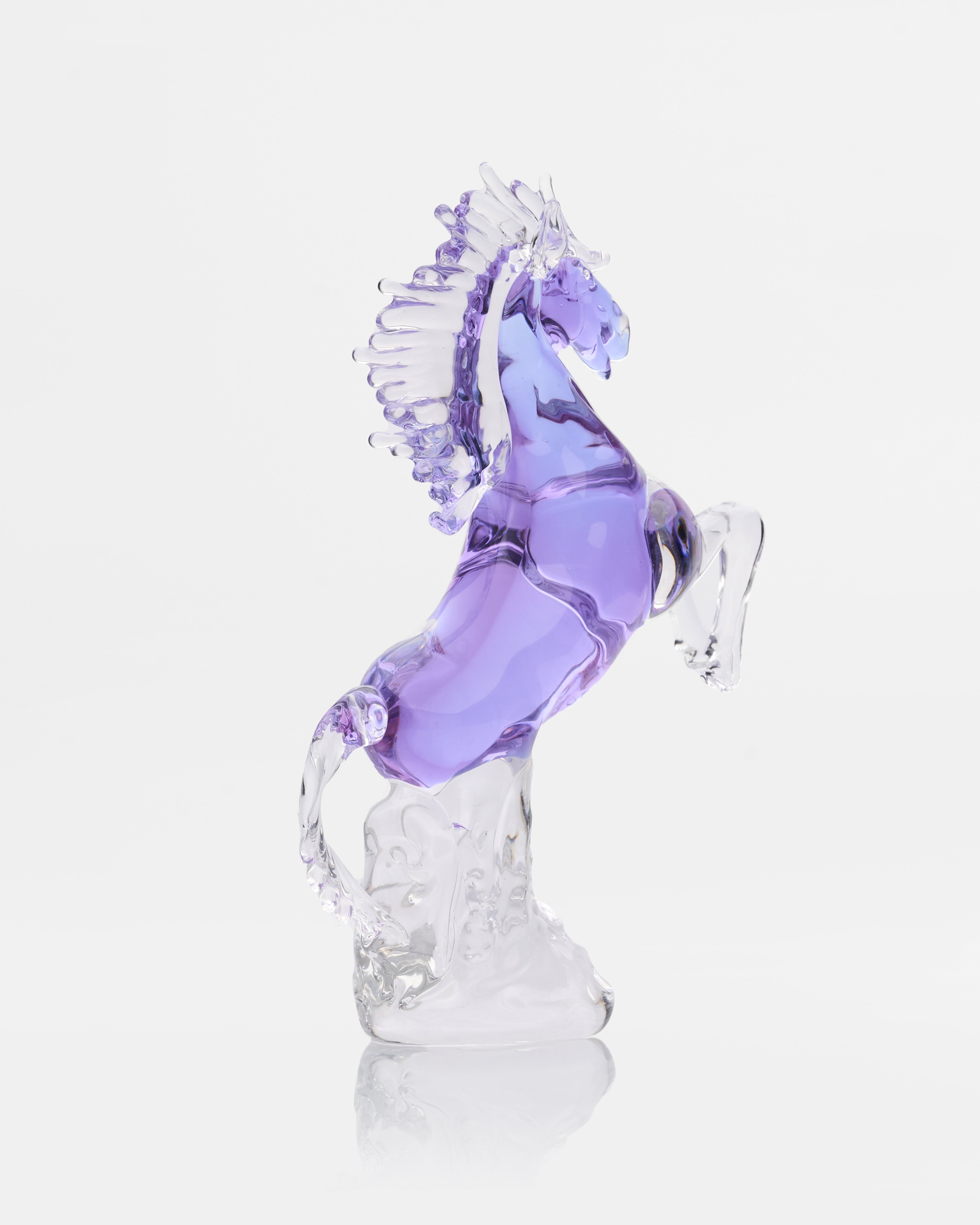 Glass sculpture of a horse with a purple mane on a white background