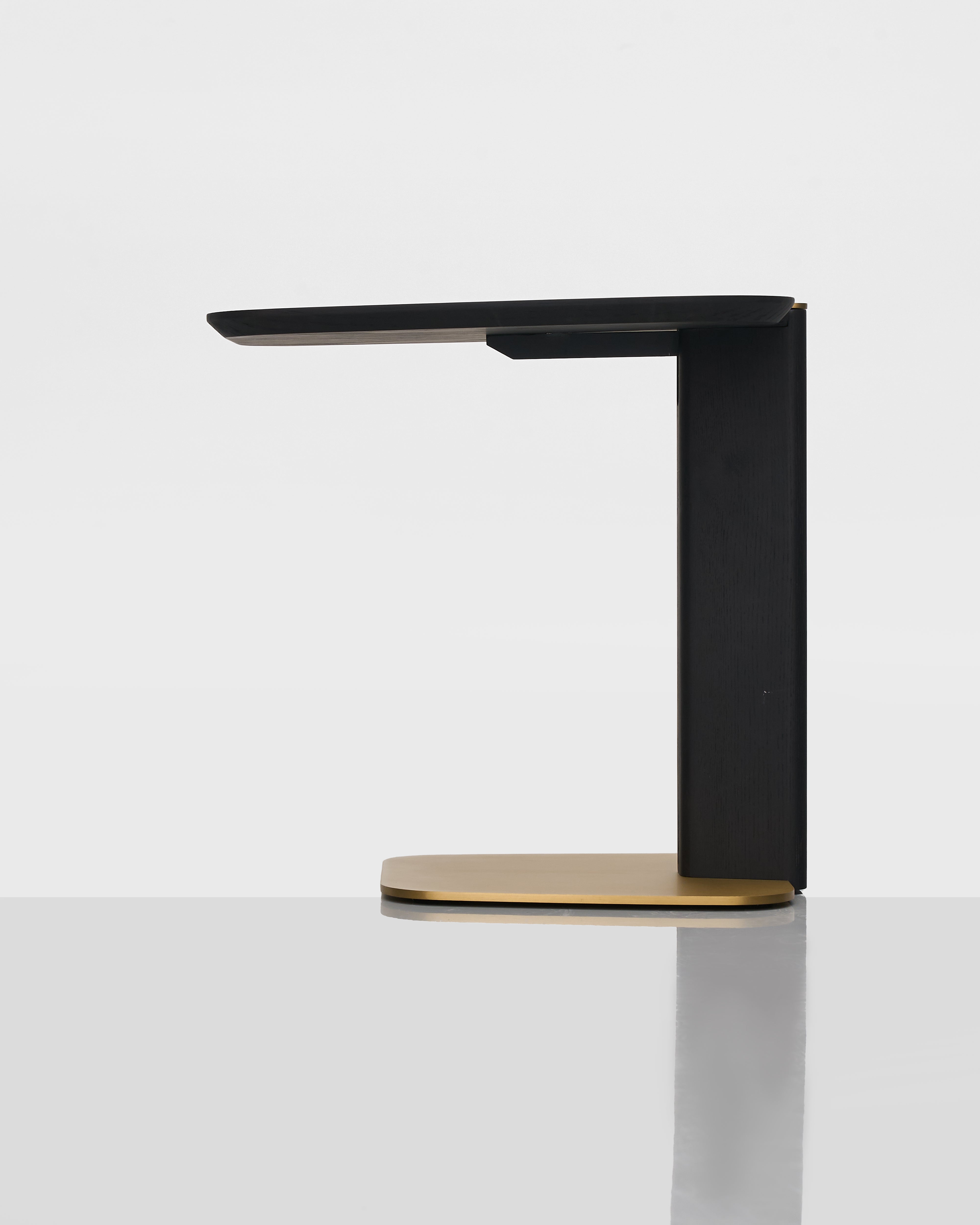 Side view of Bonna Side Table highlighting sleek wood surface and metallic gold base craftsmanship
