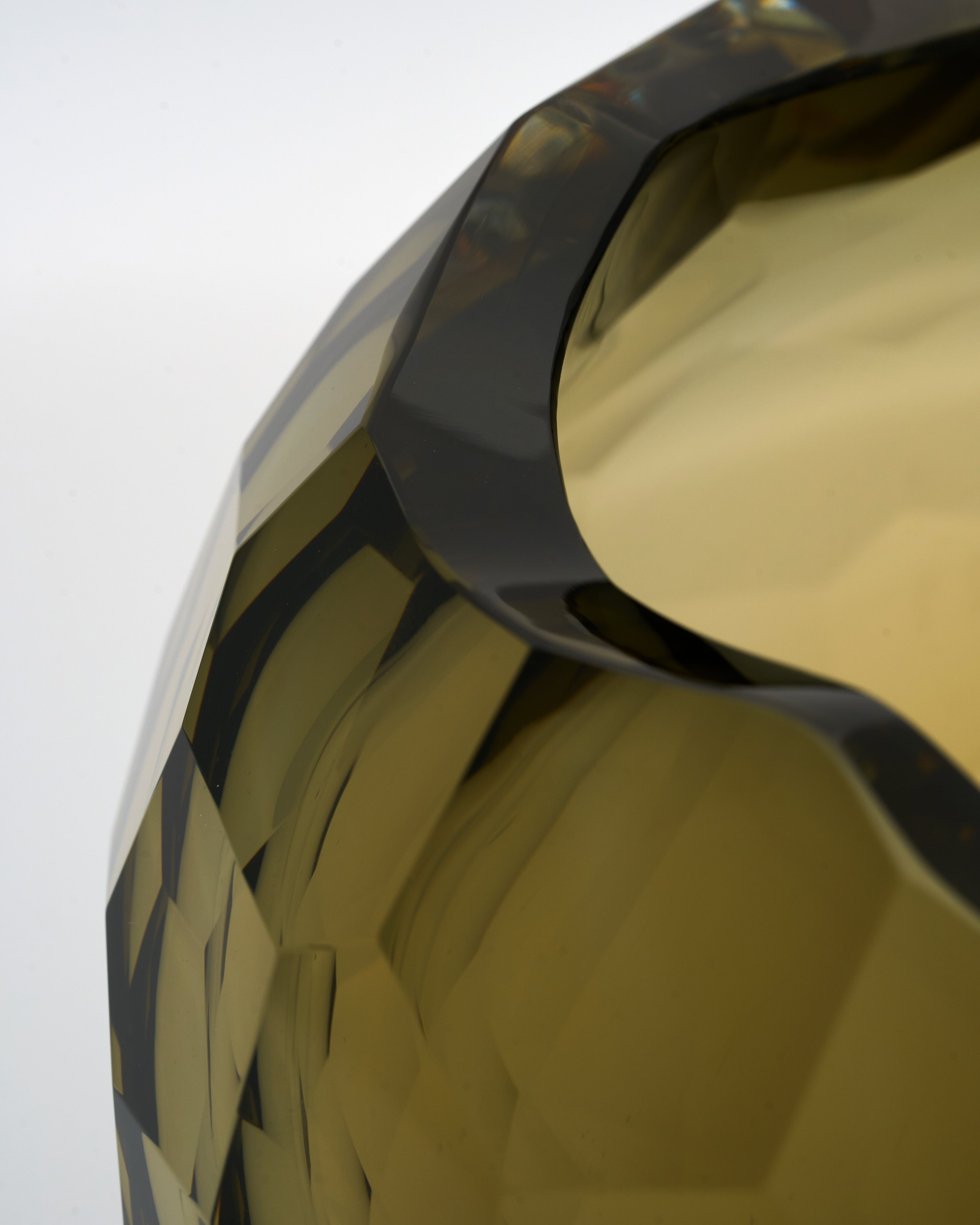 Close-up of a gold and black geometric object on a white background