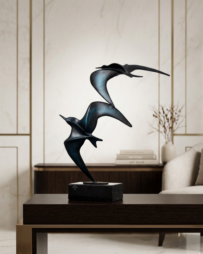 Decorative sculpture of two birds on a table in a modern living room.