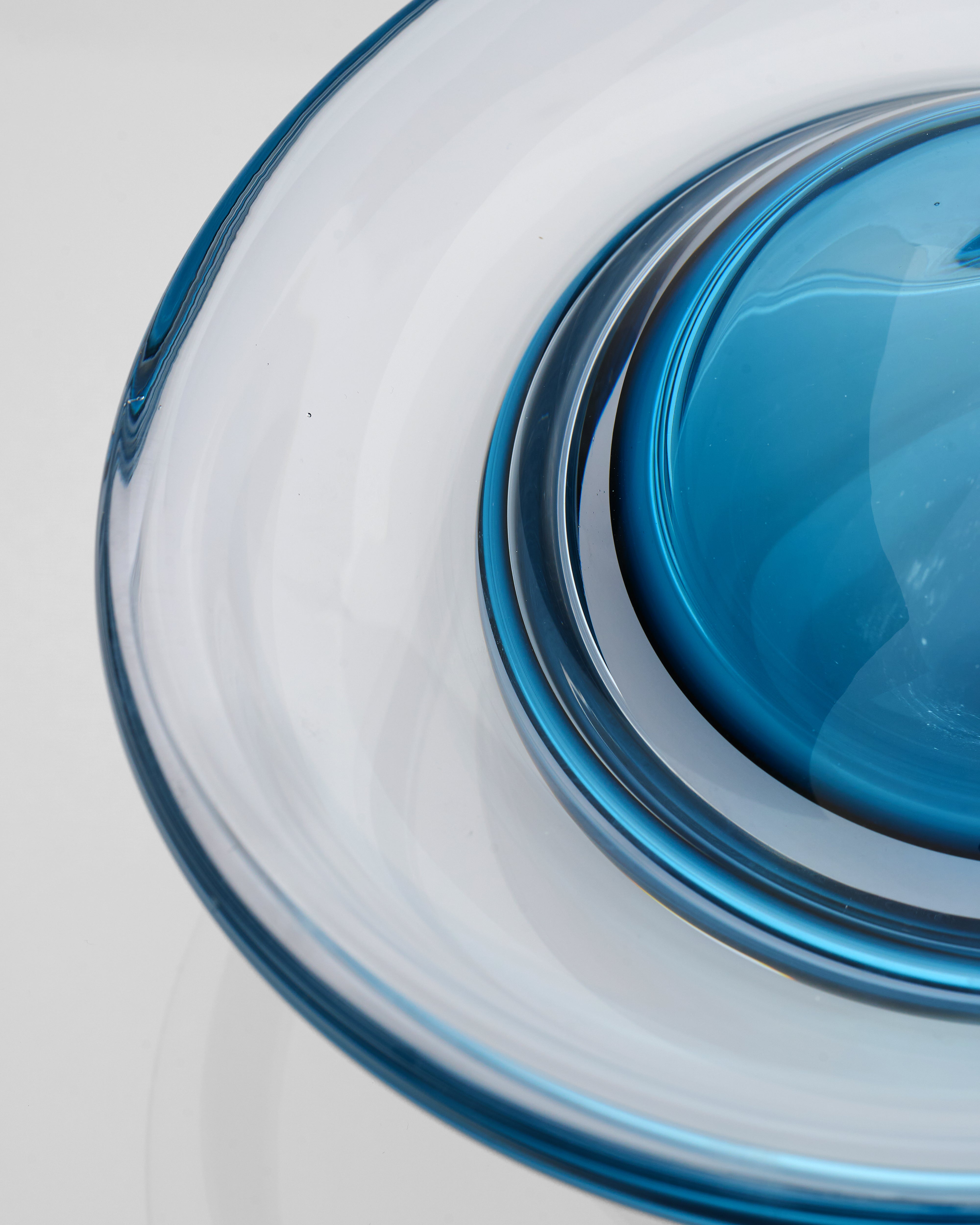 Close-up of a glass bowl with a blue rim on a white background