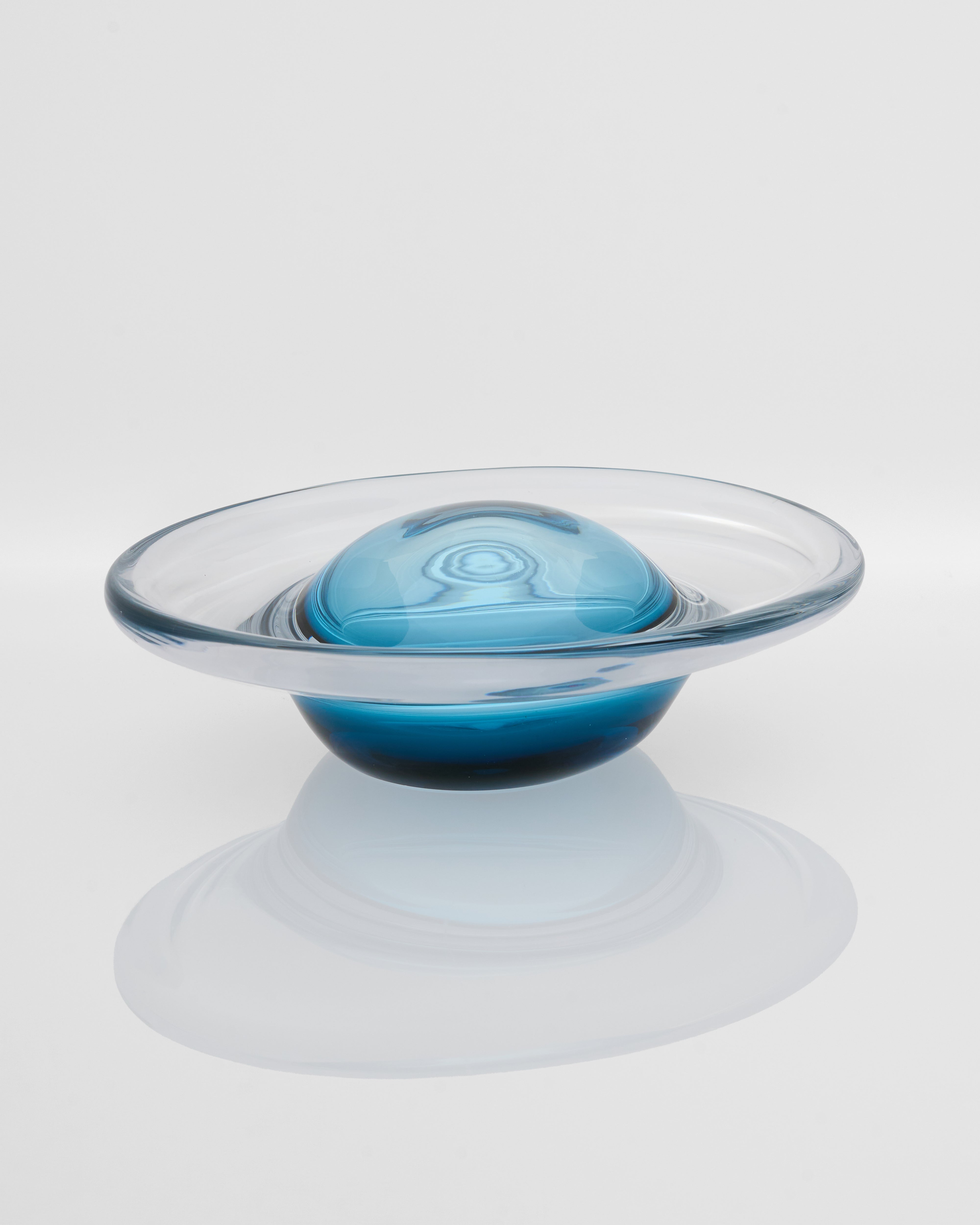 Clear glass bowl with a blue interior on a white background