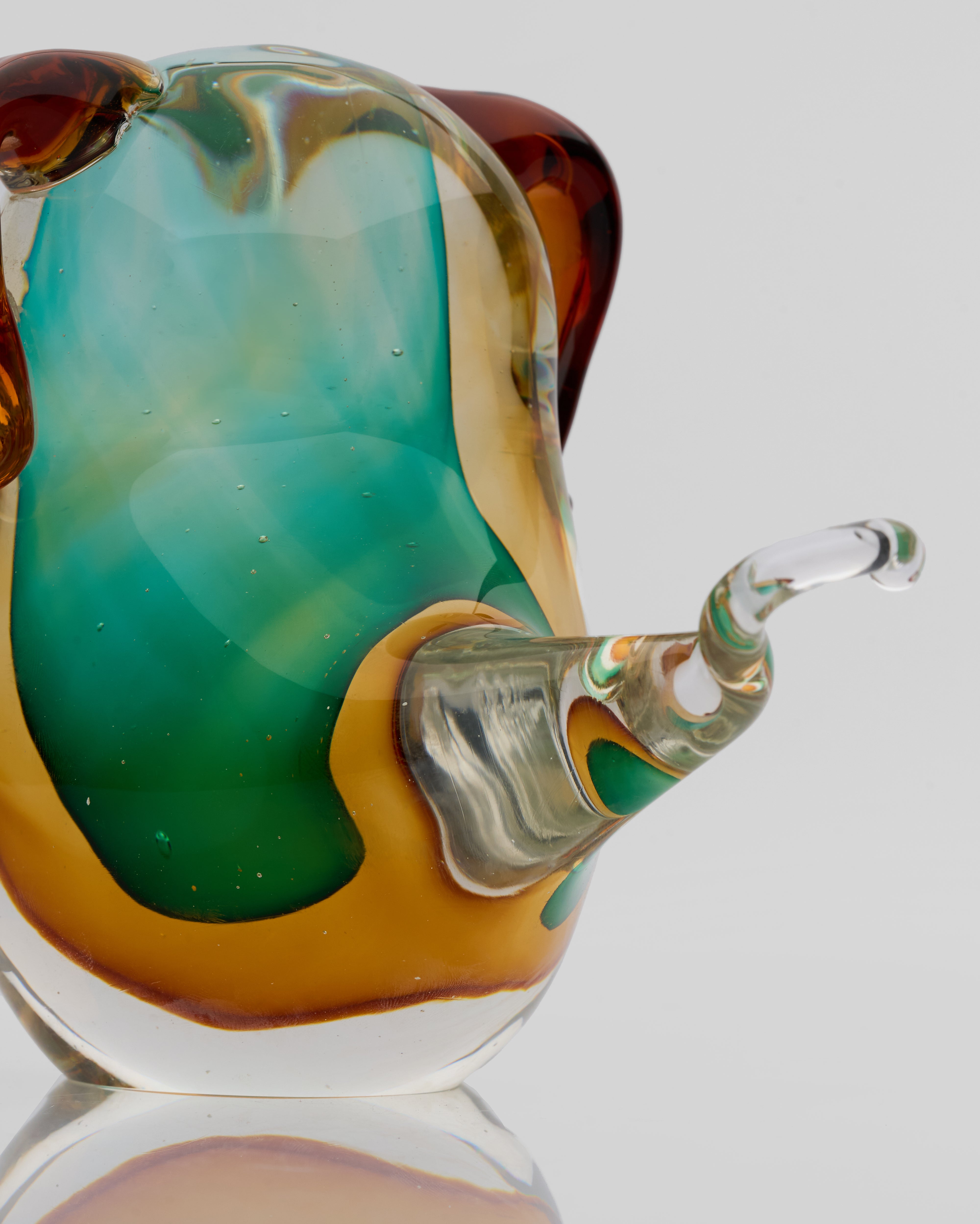 Detailed view of glossy puppy glass decor highlighting sculptural features and premium polish
