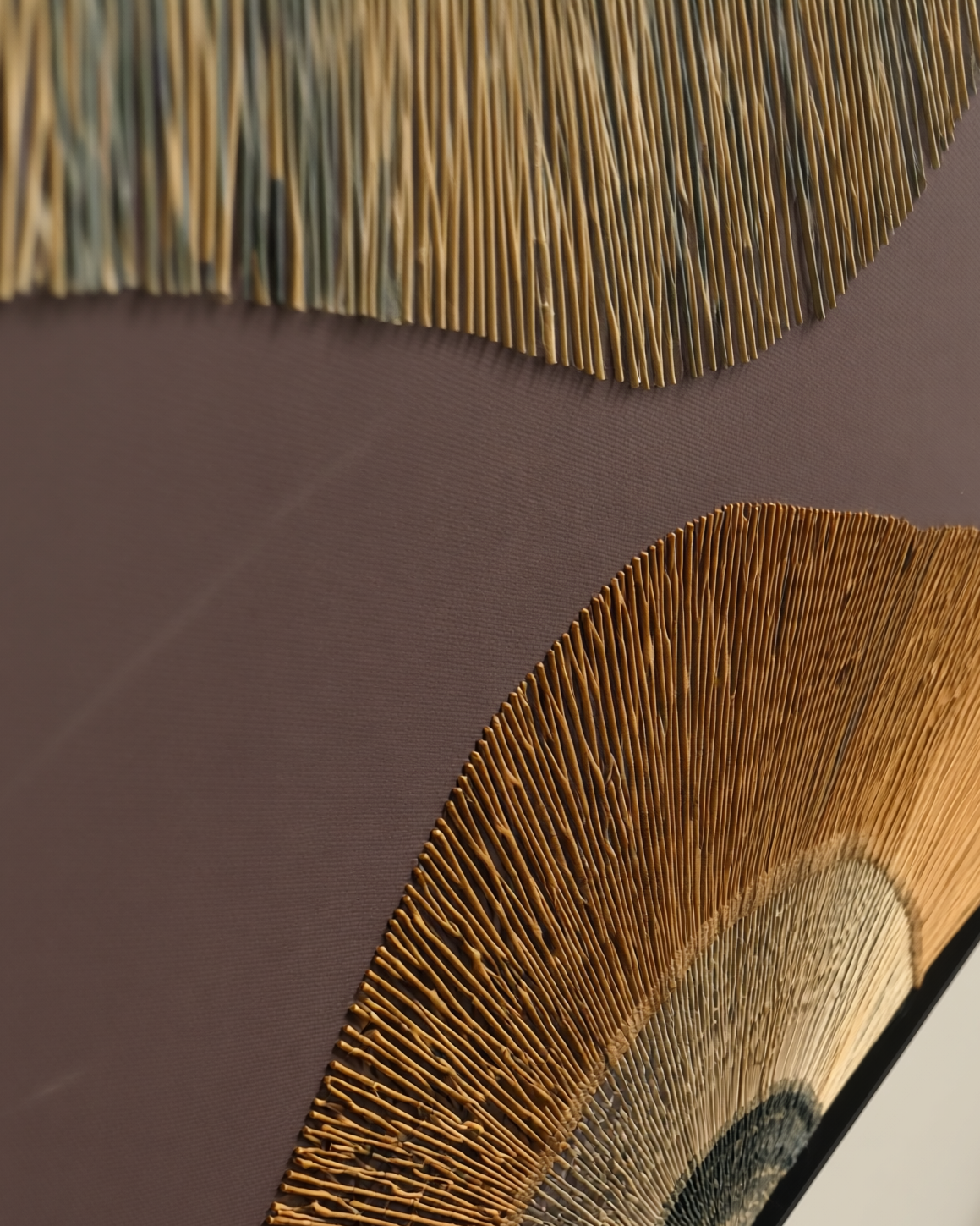 Decorative wall art with textured design on a dark background