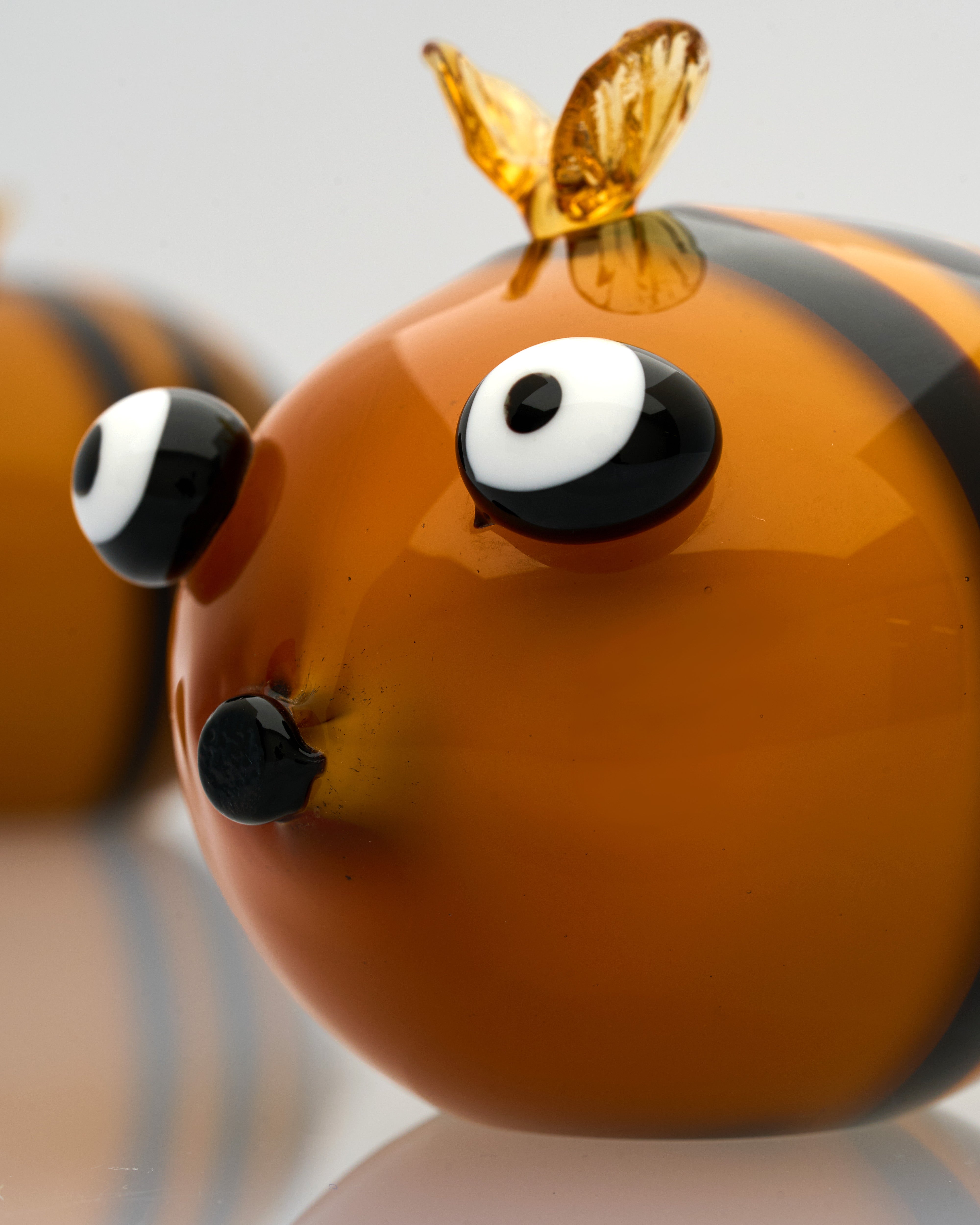 Close-up of a glass bee figurine with a clear background
