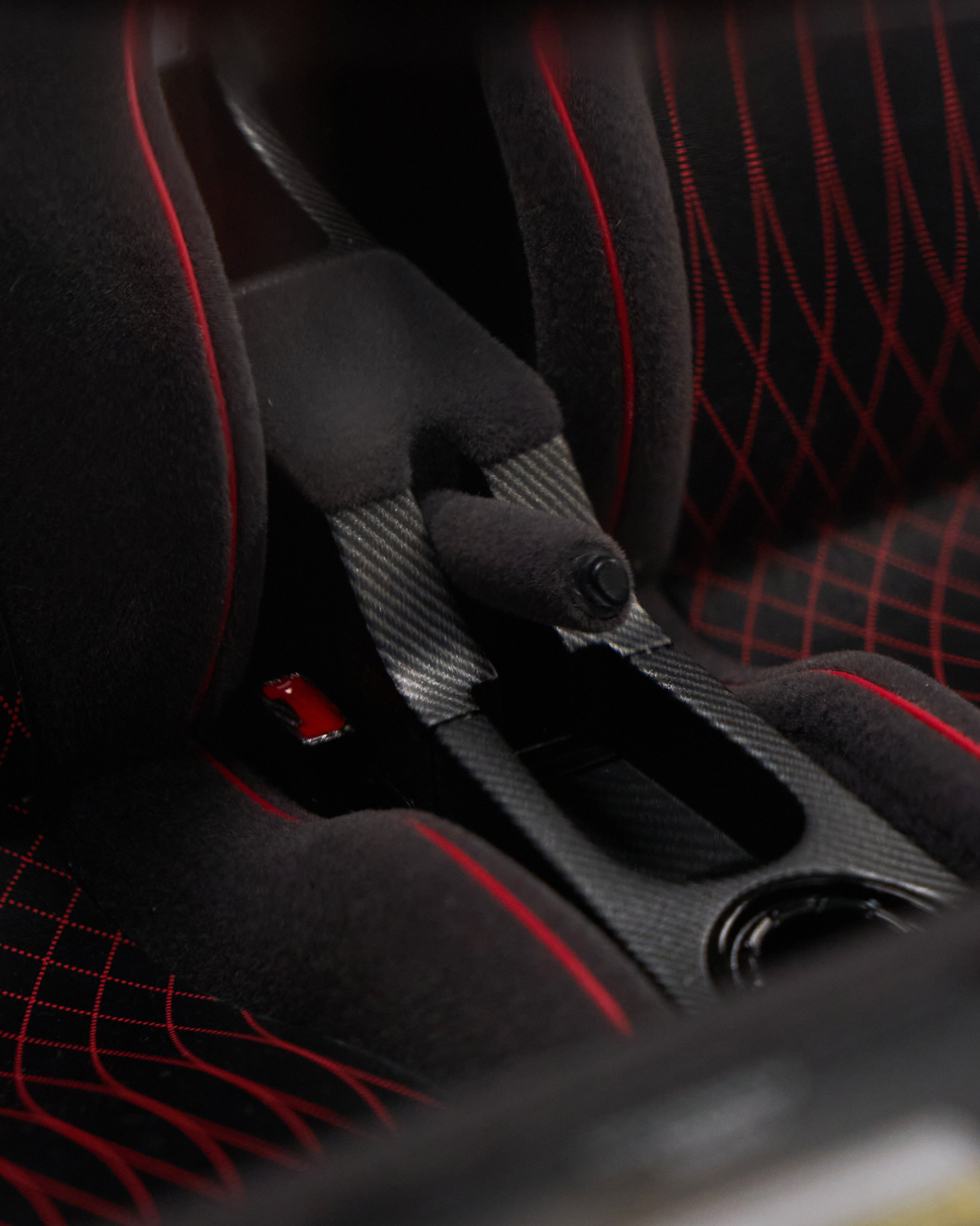 Close-up of a car seat with red stitching details