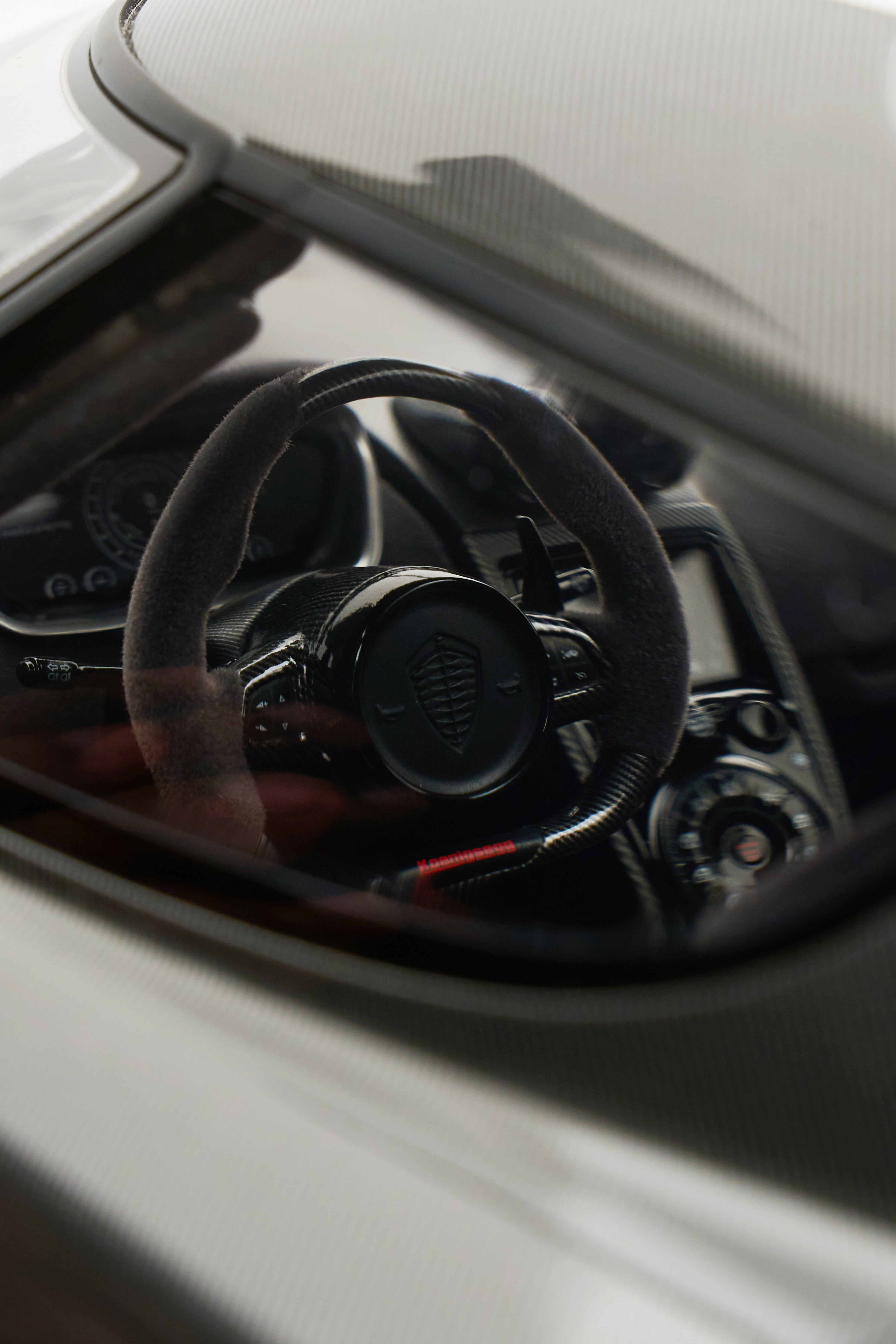 Steering wheel and dashboard of a car with a visible brand logo.