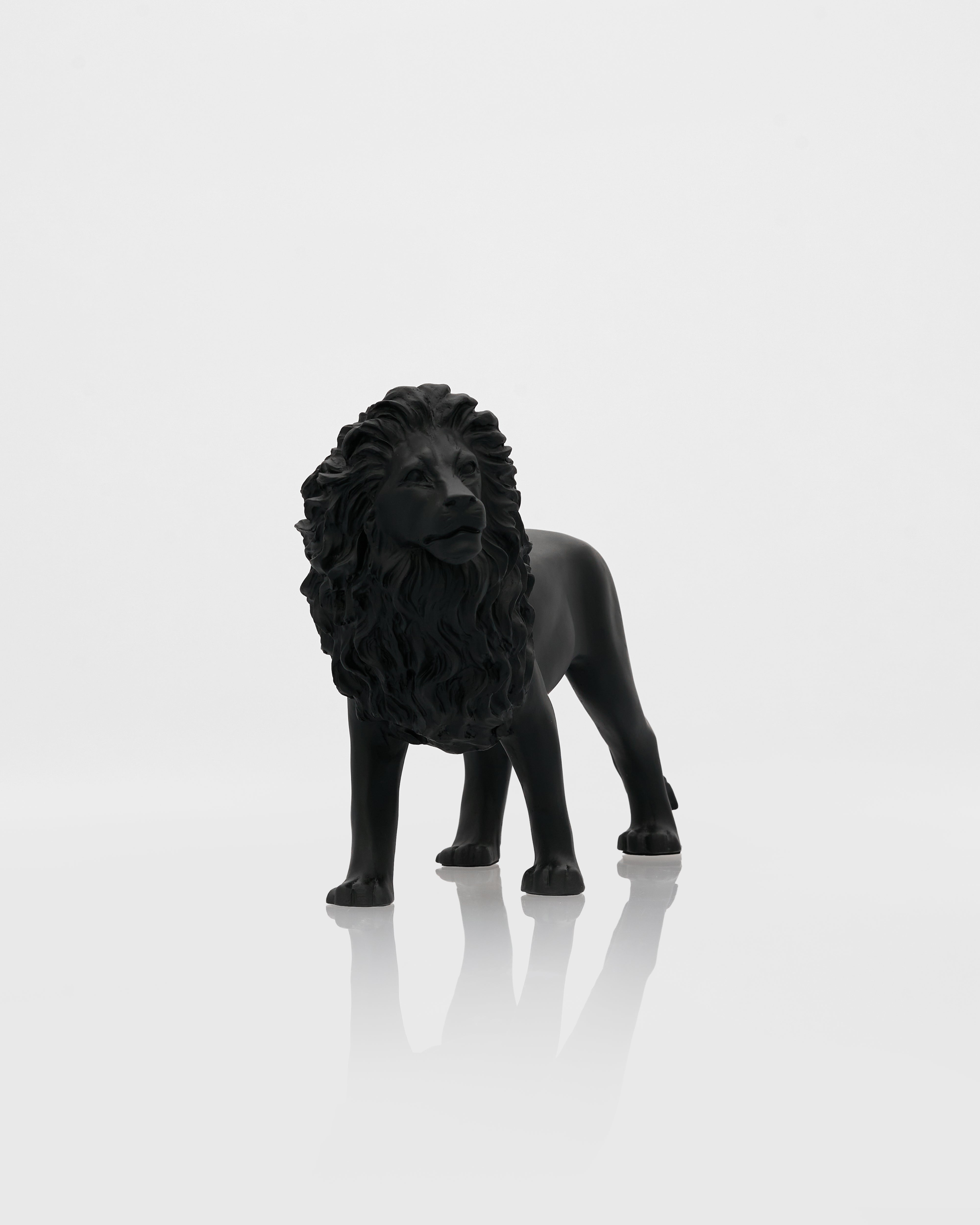 Black lion statue on a white background ceramic figurine