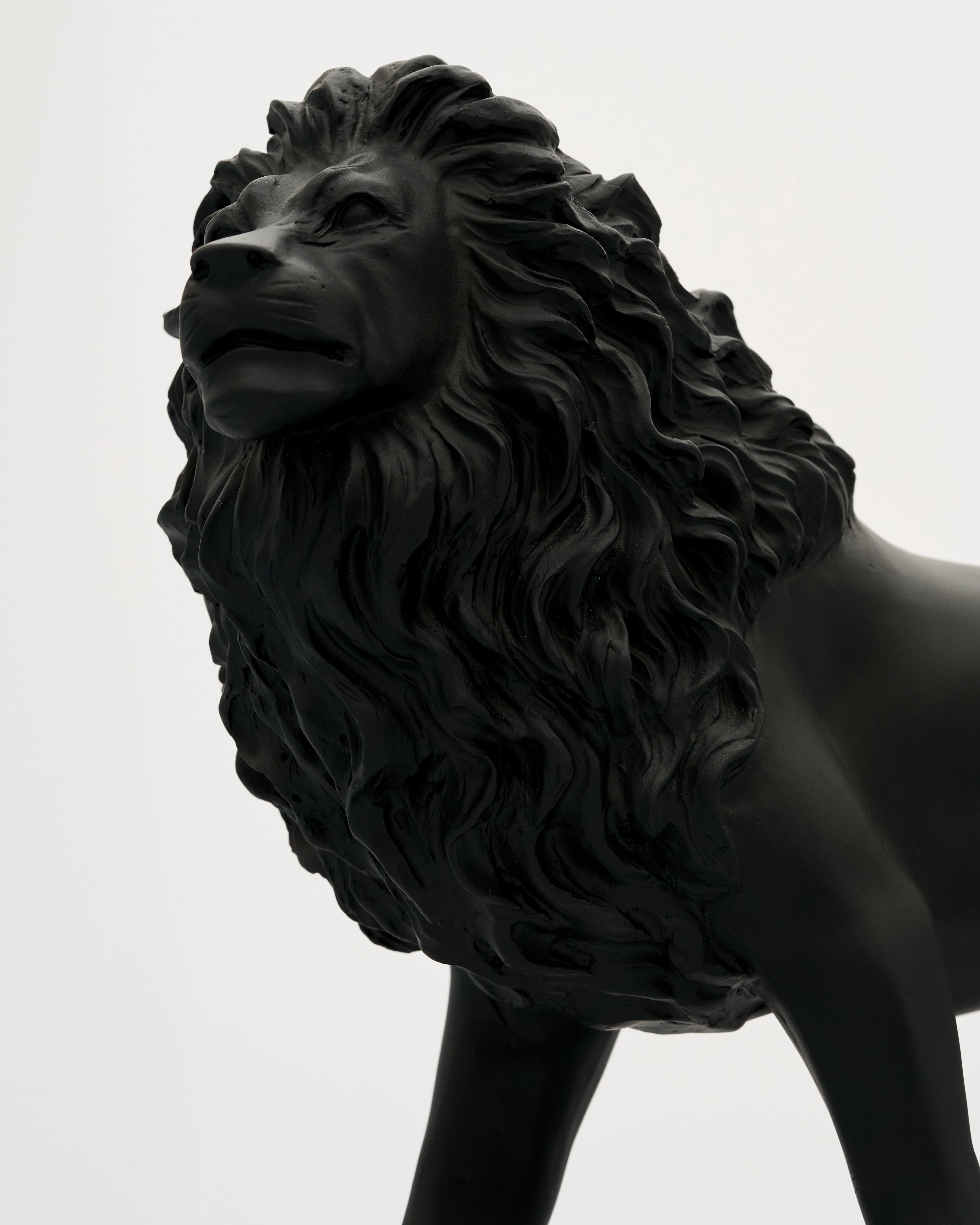 Black lion statue on a white background