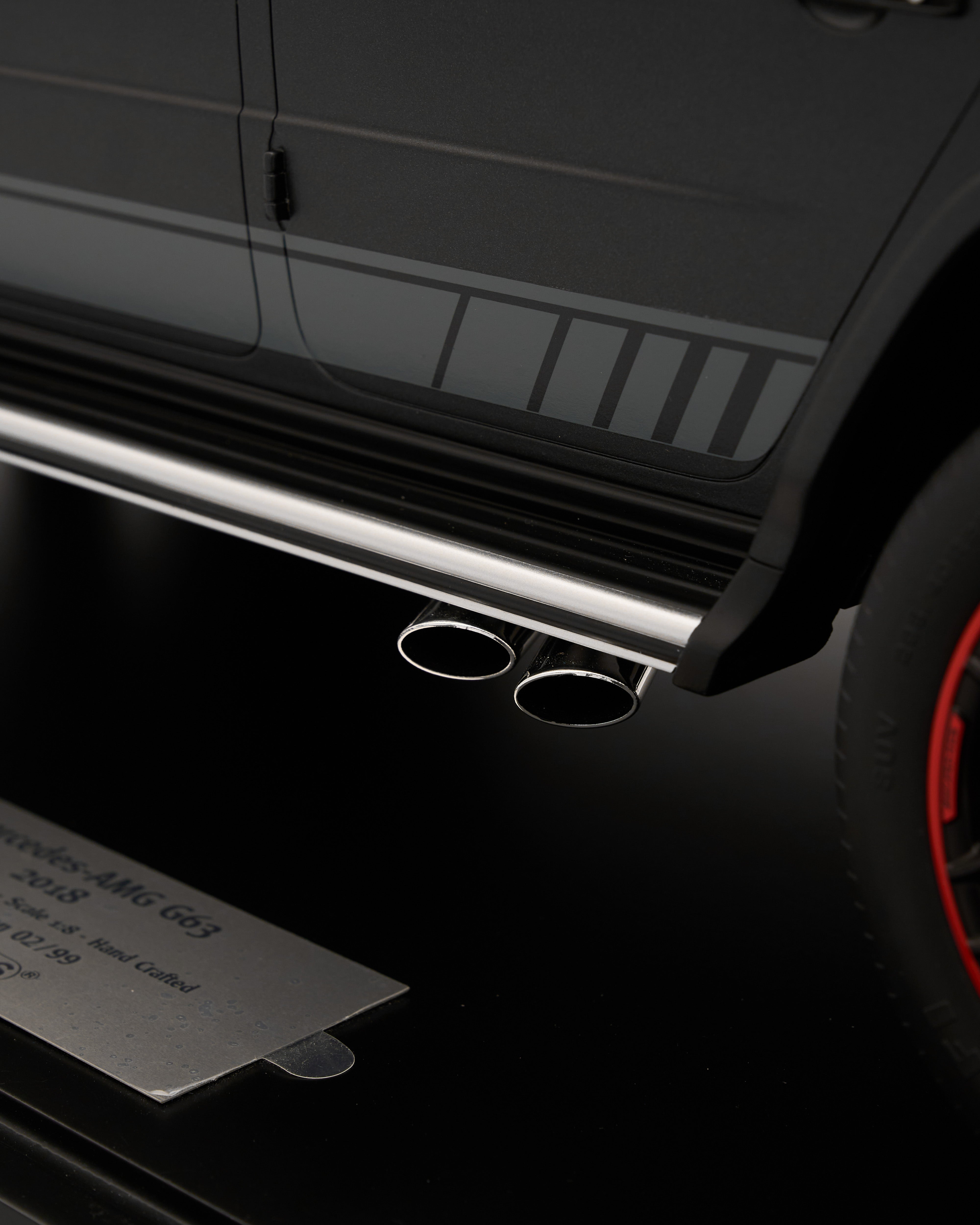 Close-up of a car's exhaust system with a focus on the dual exhaust pipes.