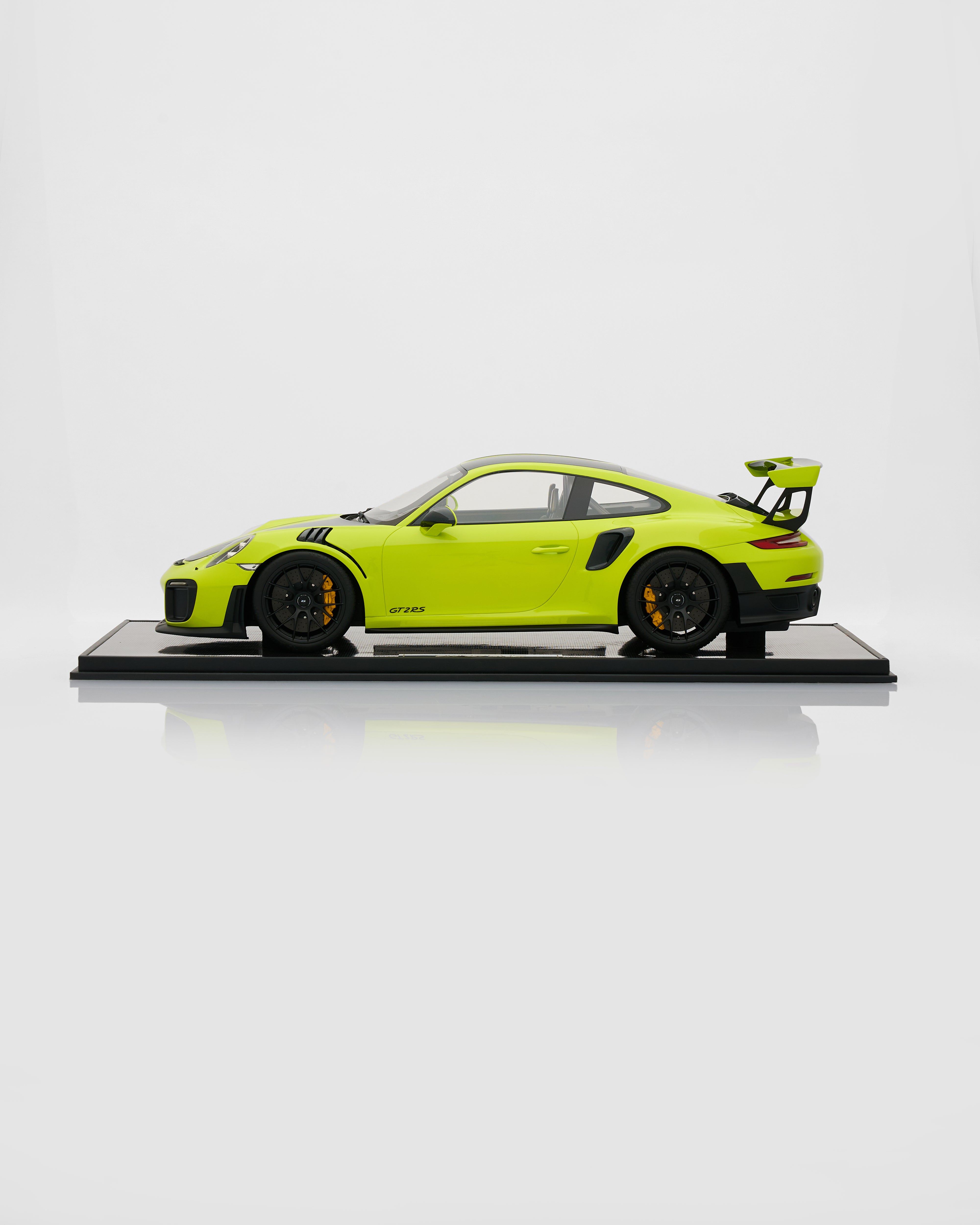 Model of a lime green sports car on a white background