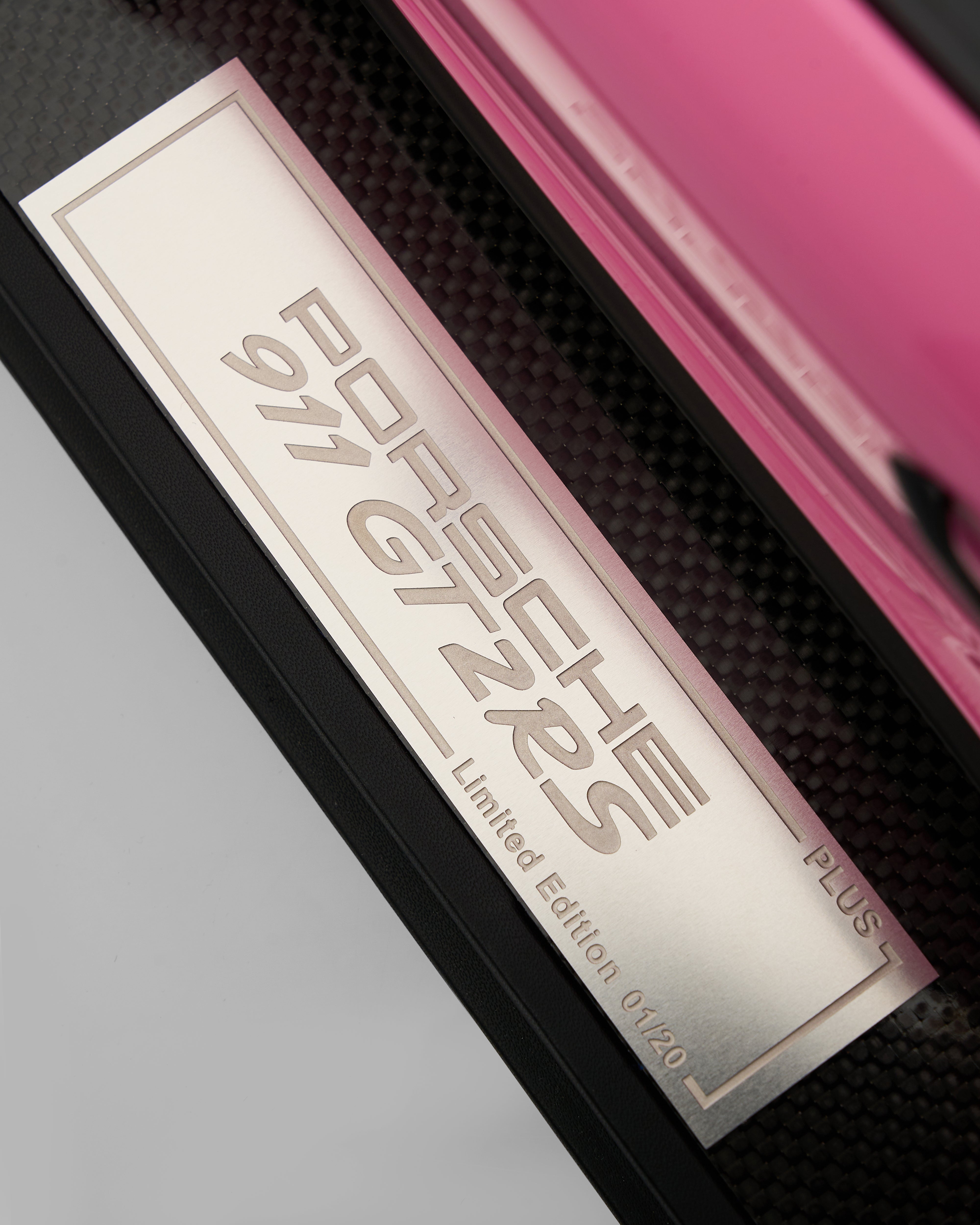 Close-up of a Porsche 911 GT2 RS Limited Edition label on a pink car.