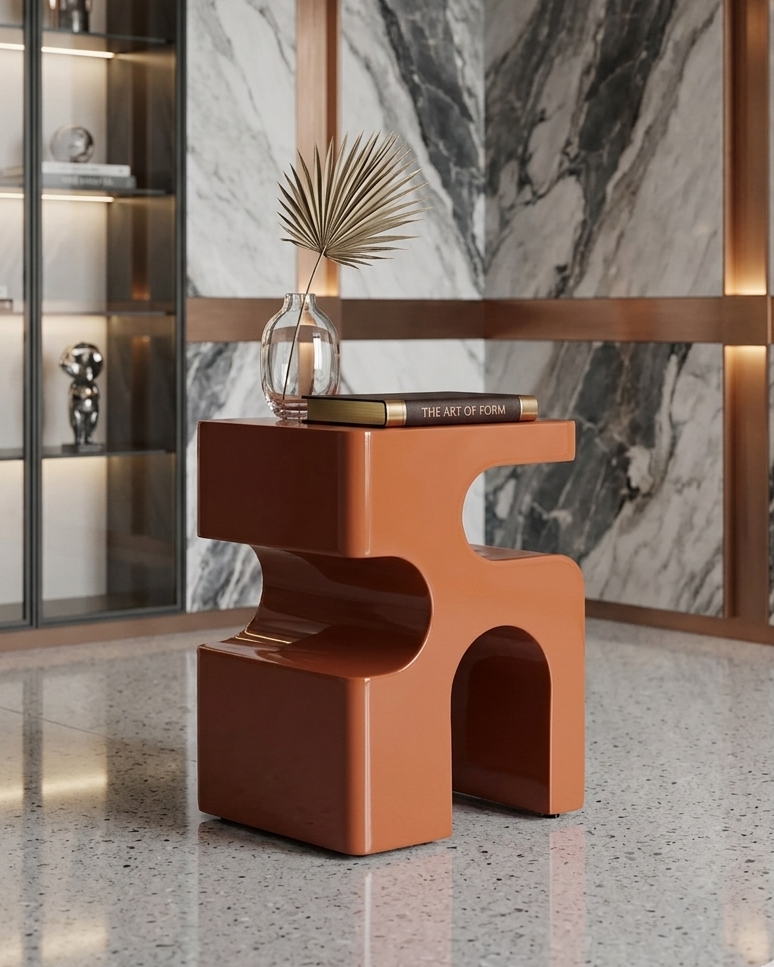 Modern brown side table with decorative items against a marble wall.