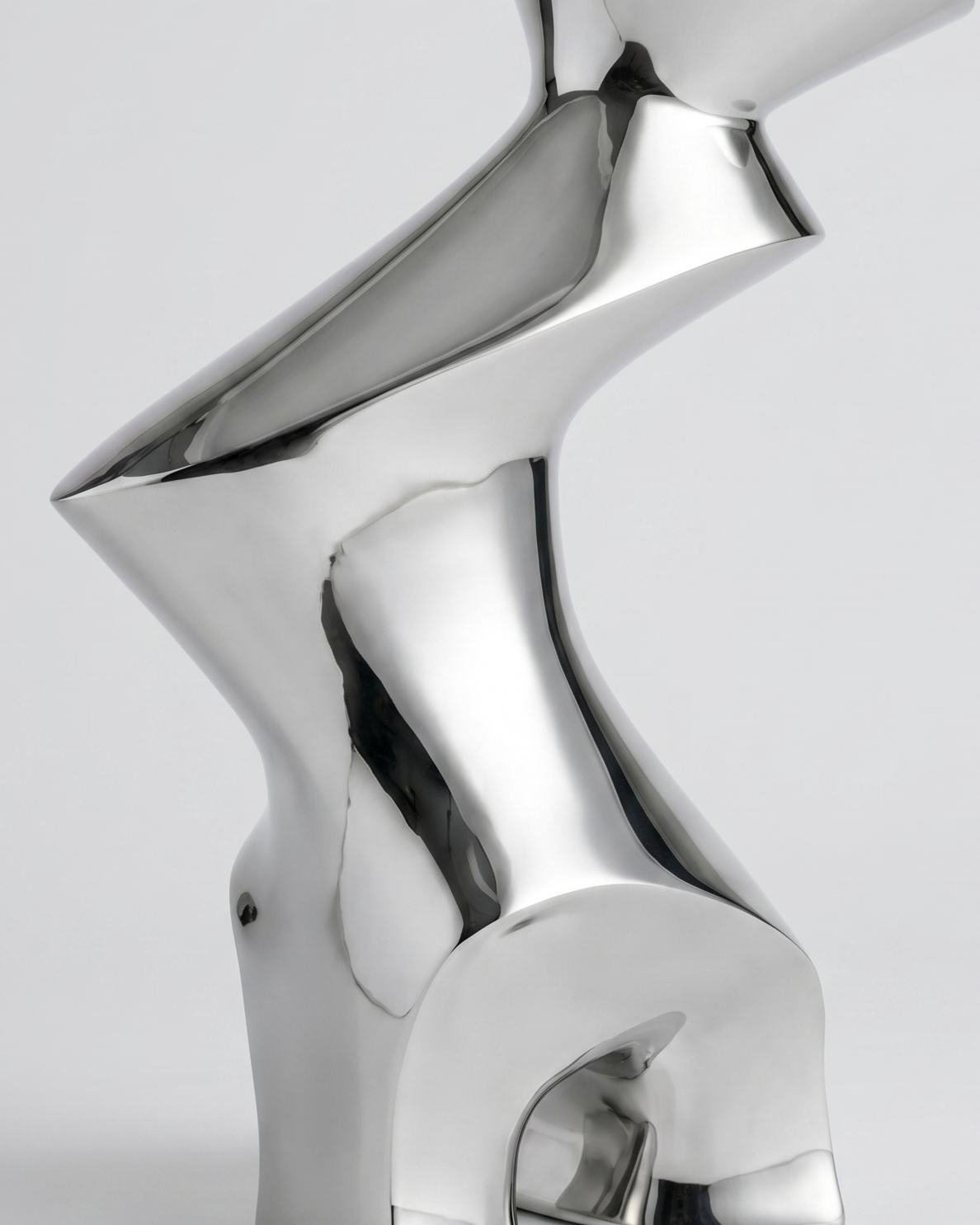 Silver abstract sculpture on a light gray background
