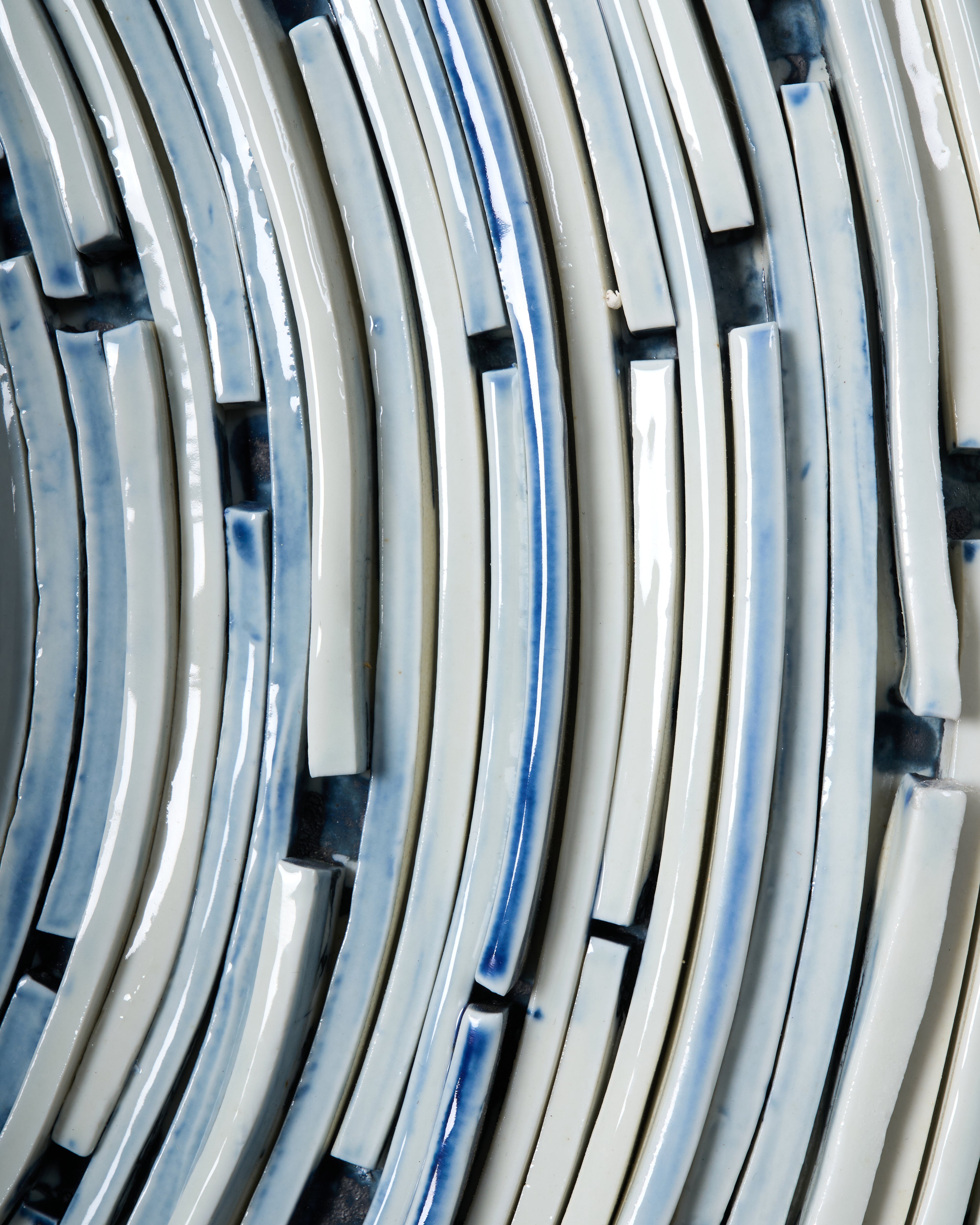 Close-up of curved metal strips with a reflective surface