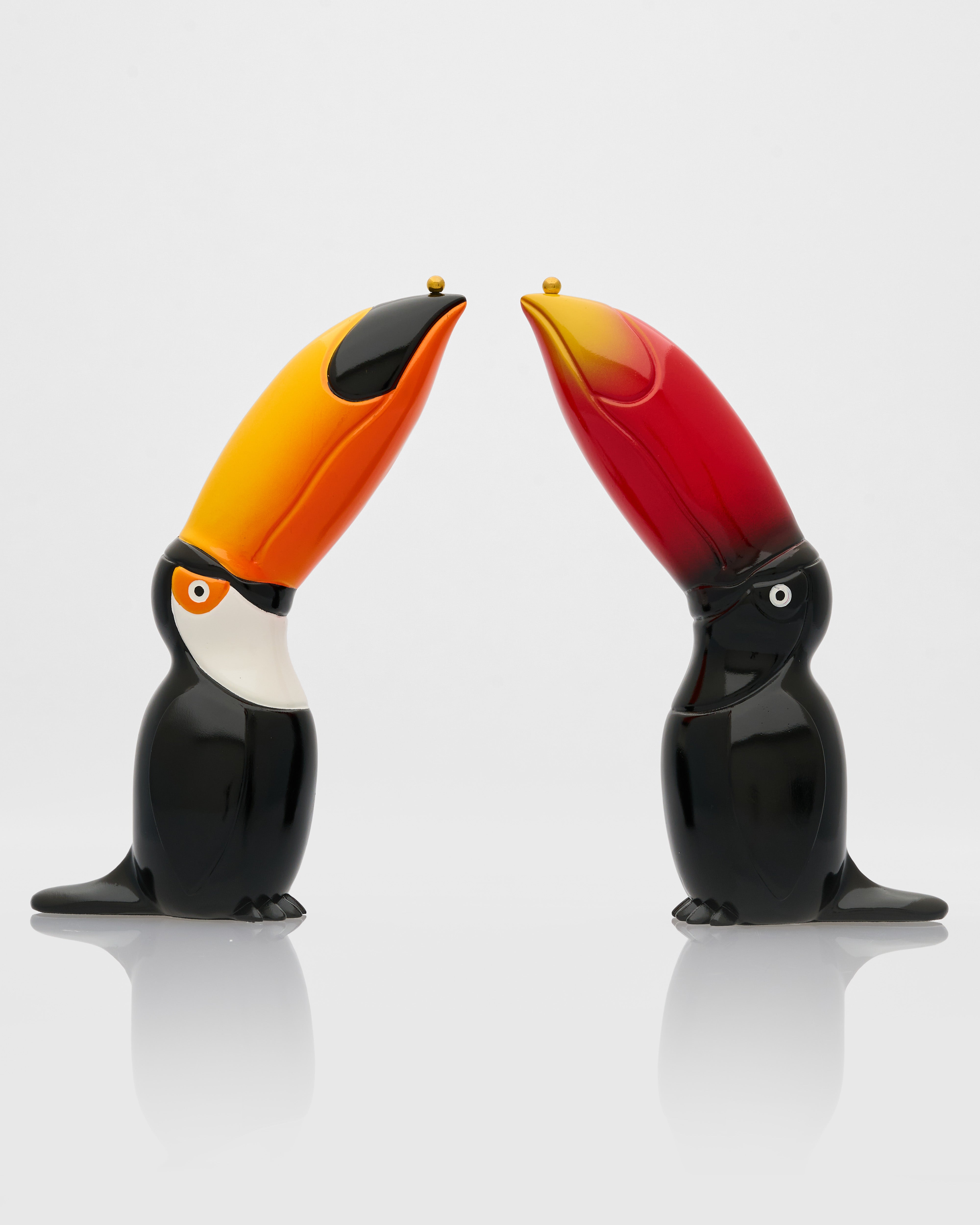 Two toucan-shaped salt and pepper shakers on a white background