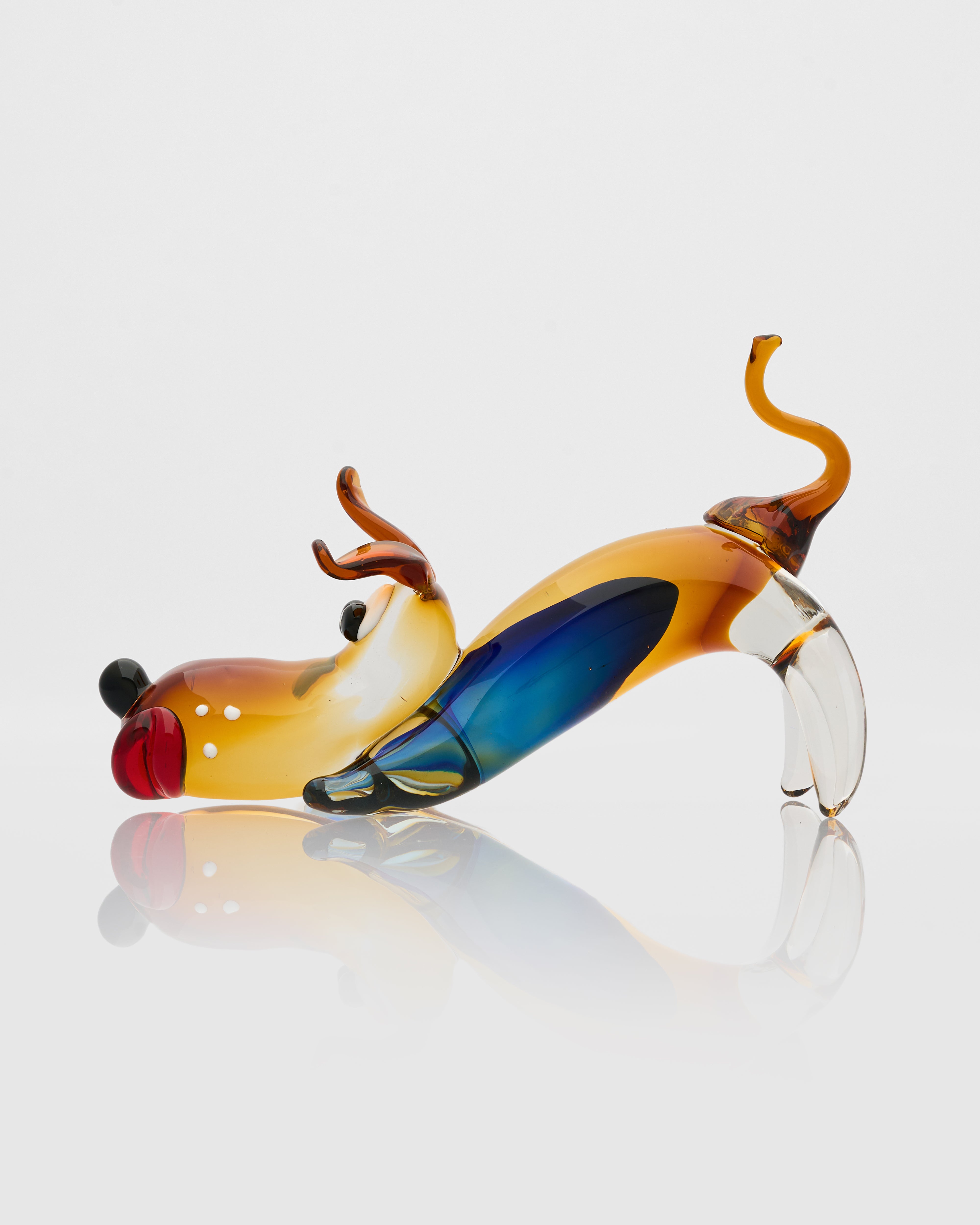 Glass sculpture of a dog on a white background