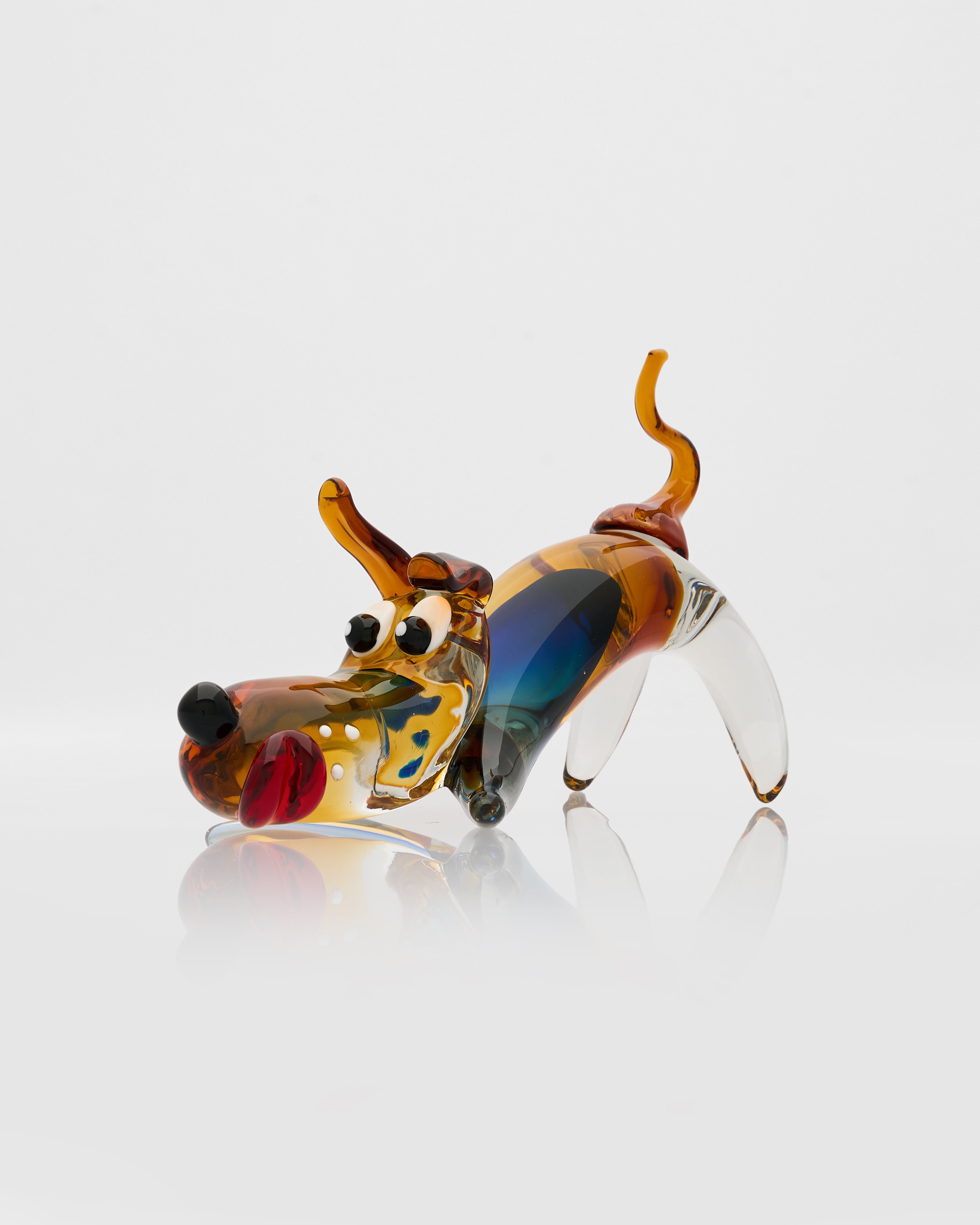 Glass dog figurine with multicolored finish on a white background